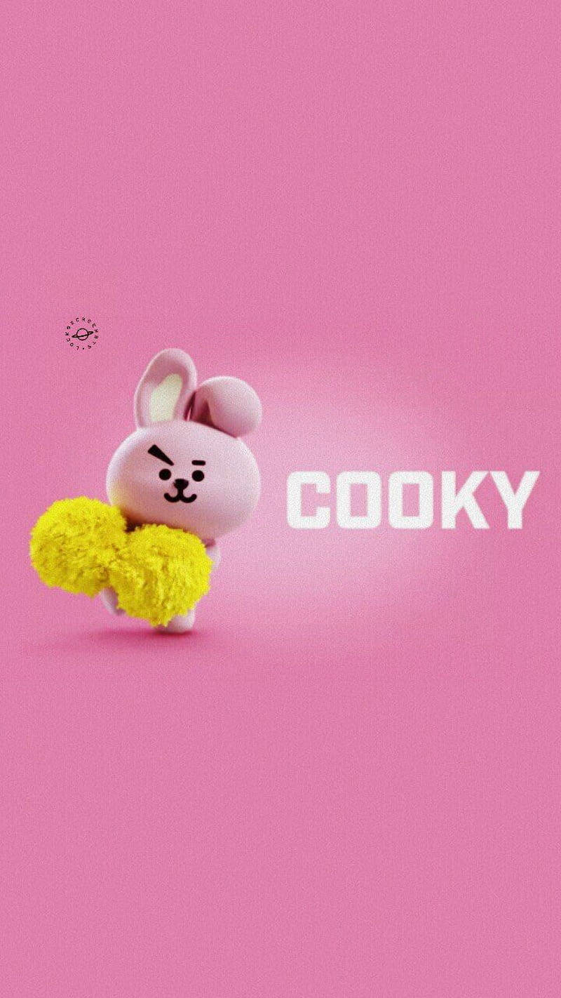 Cooky Bt21 桌布 壁紙 — 一個可愛的粉紅色兔子角色手持黃色絨球，站在純粉紅色背景前，背景上有白色文字 'COOKY'。