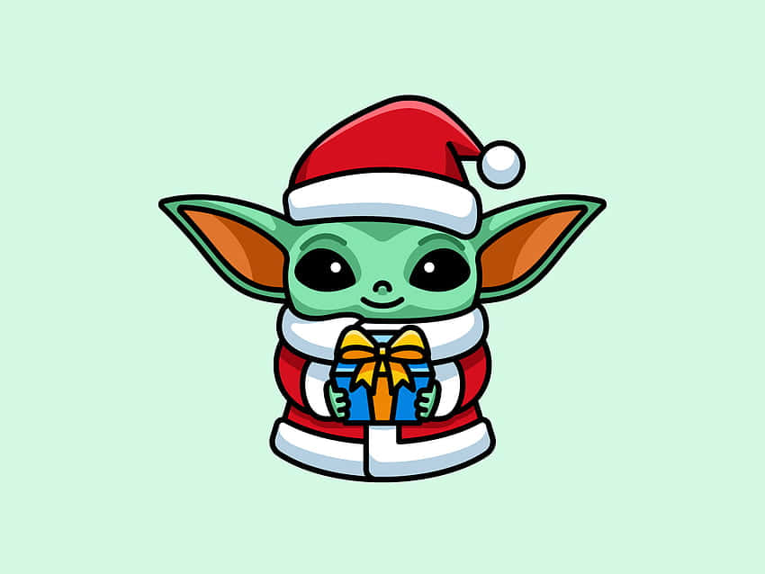 Baby Yoda Christmas 桌布 壁紙 — 一個可愛的綠色嬰兒尤達，戴著紅色聖誕帽和穿著紅色聖誕套裝，拿著一個帶有黃色蝴蝶結的藍色禮物。