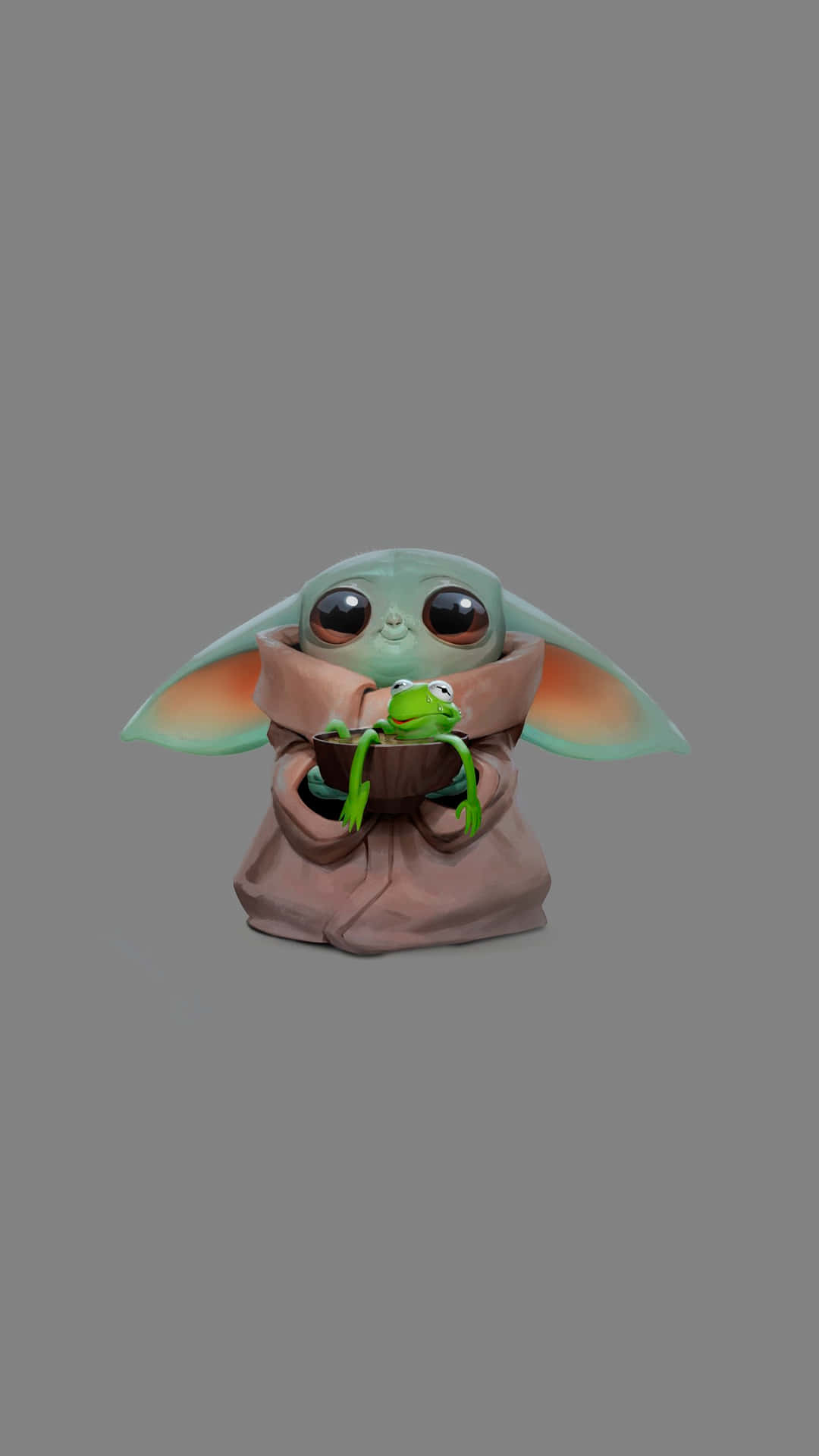 Baby Yoda iPhone 桌布 壁紙 — 一個可愛的綠色嬰兒尤達在一個棕色碗裡拿著一隻小青蛙，背景是純灰色。