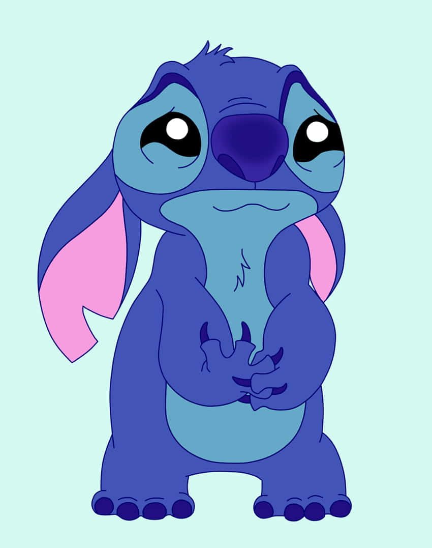 Sad Stitch 桌布 壁紙 — 一個可愛的藍色外星人，有粉紅色耳朵，站在淺藍色背景前，睜大眼睛看起來很傷心。