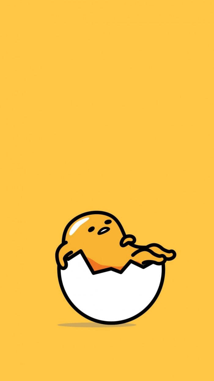 Gudetama Aesthetic 桌布 壁紙 — 一個可愛的黃色卡通角色從裂開的雞蛋中探出頭來，背景是純黃色。