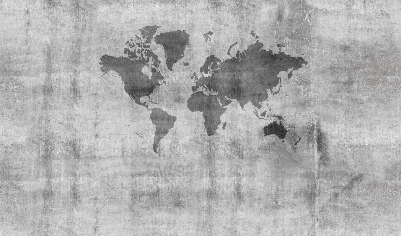 World 桌布 壁紙 — 一個單色世界地圖輪廓蝕刻在風化的混凝土牆上，帶有可見裂縫和紋理。