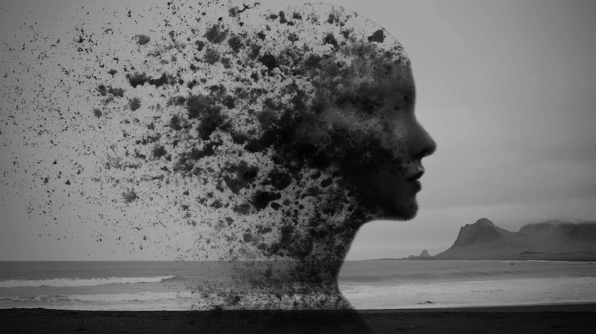 Surreal Profile of a Disintegrating Human Form by the Sea 壁紙 — 一個單色的人類頭部剪影，在海岸背景下逐漸分解成粒子，遠方有懸崖。