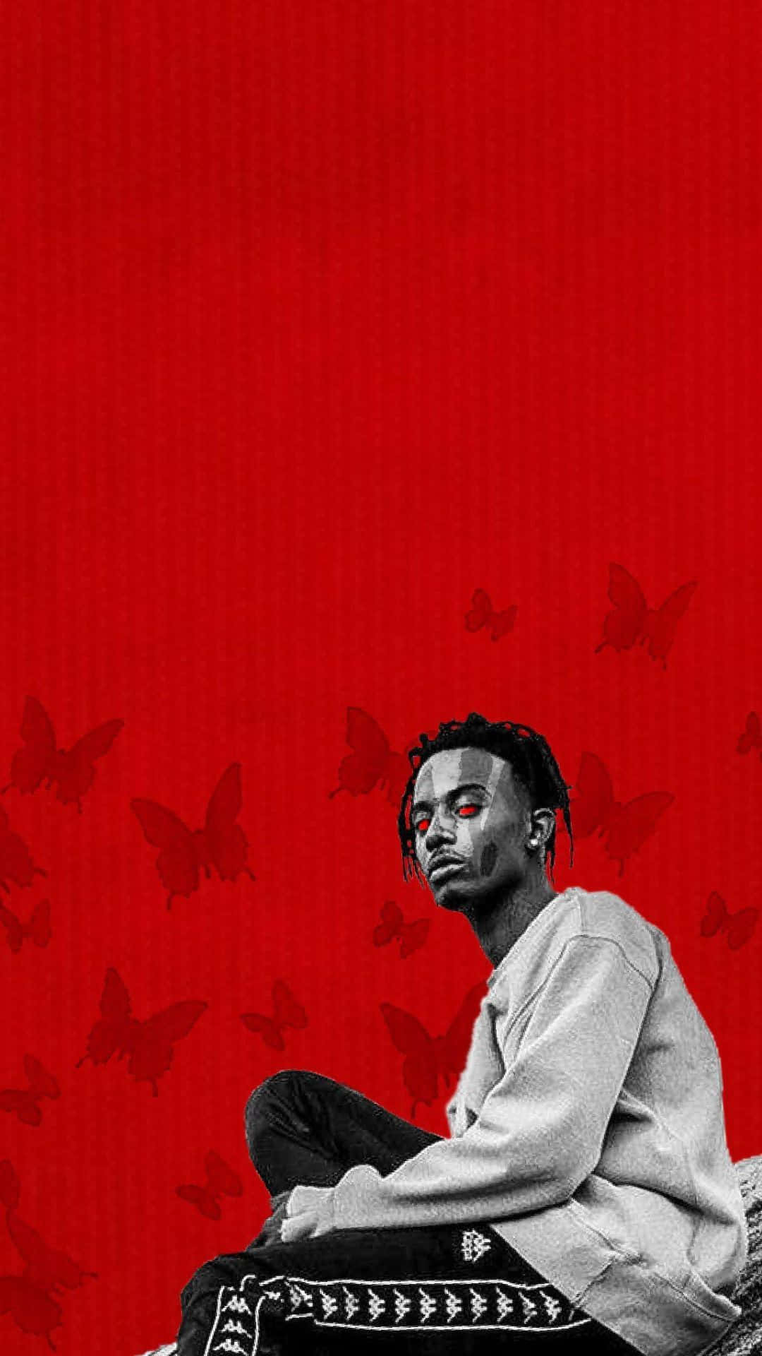 Playboi Carti iPhone 桌布 壁紙 — 一個單色調的紅眼男人平靜地坐在充滿漂浮蝴蝶的鮮紅色背景前。