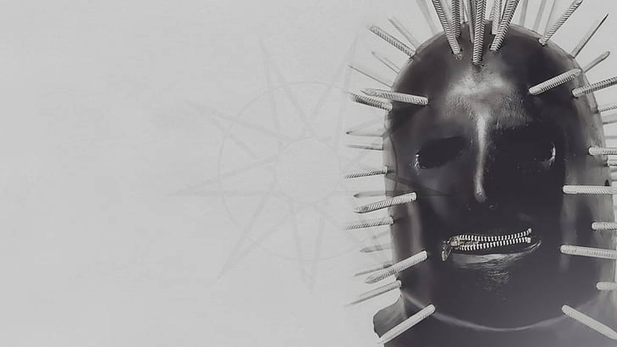 craig jones 桌布 壁紙 — 一個單色面具，帶有拉鍊嘴巴和向外輻射的尖刺，背景為純色。