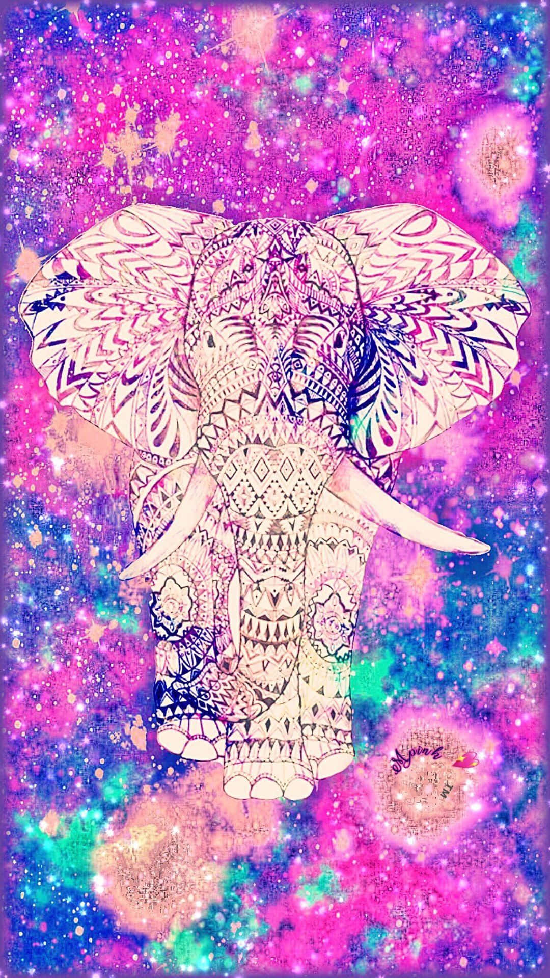 Pink Elephant 桌布 壁紙 — 一個圖案複雜的大象頭漂浮在充滿粉紅色、紫色和藍綠色星星的鮮豔宇宙星雲中。