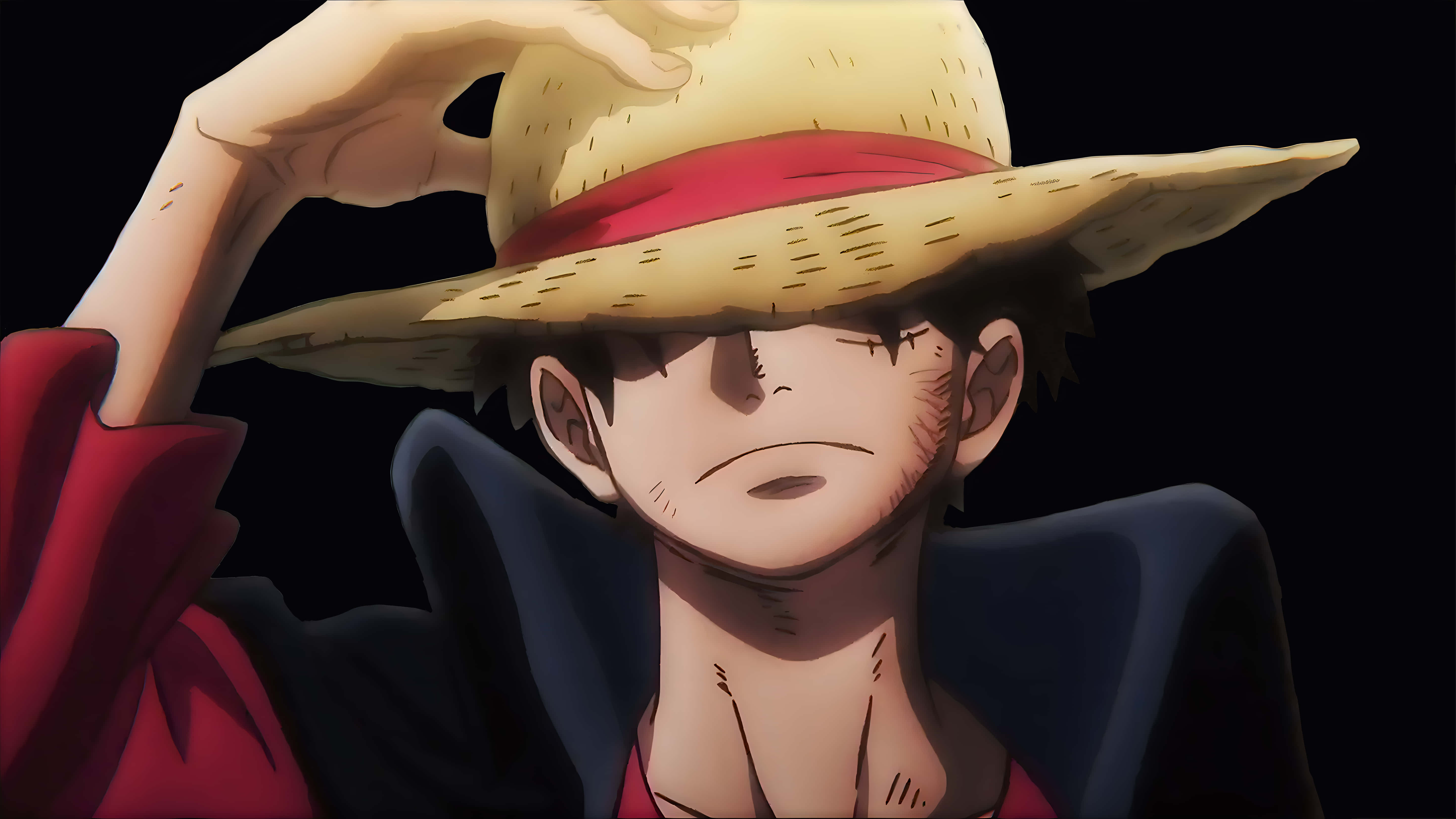 Luffy 桌布 壁紙 — 一個堅定的動漫海盜，戴著草帽和紅色襯衫，在黑暗背景前向前傾。