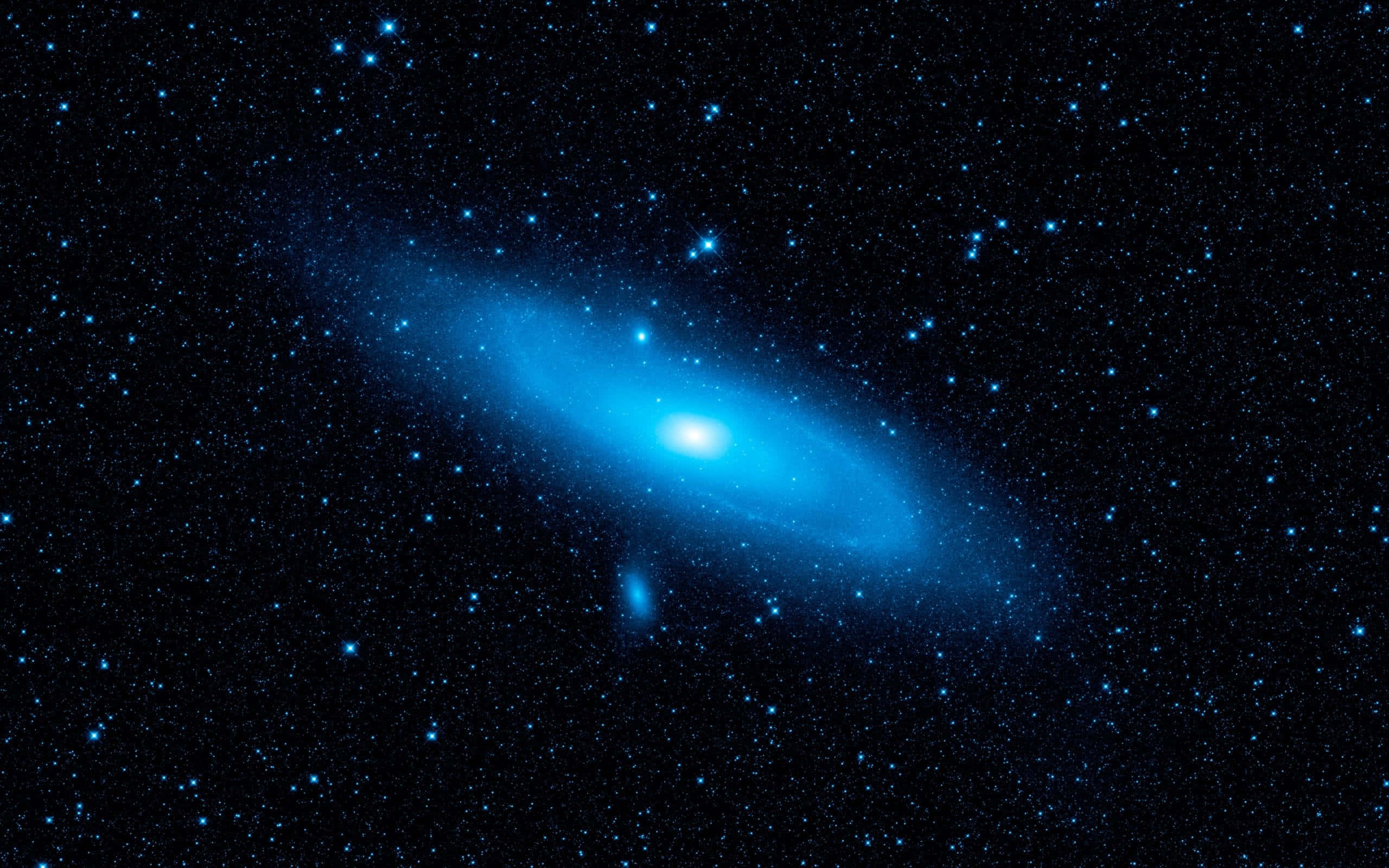 宇宙 桌布 壁紙 — 一個壯觀的螺旋星系在佈滿星星的宇宙背景下發出鮮豔的藍光。