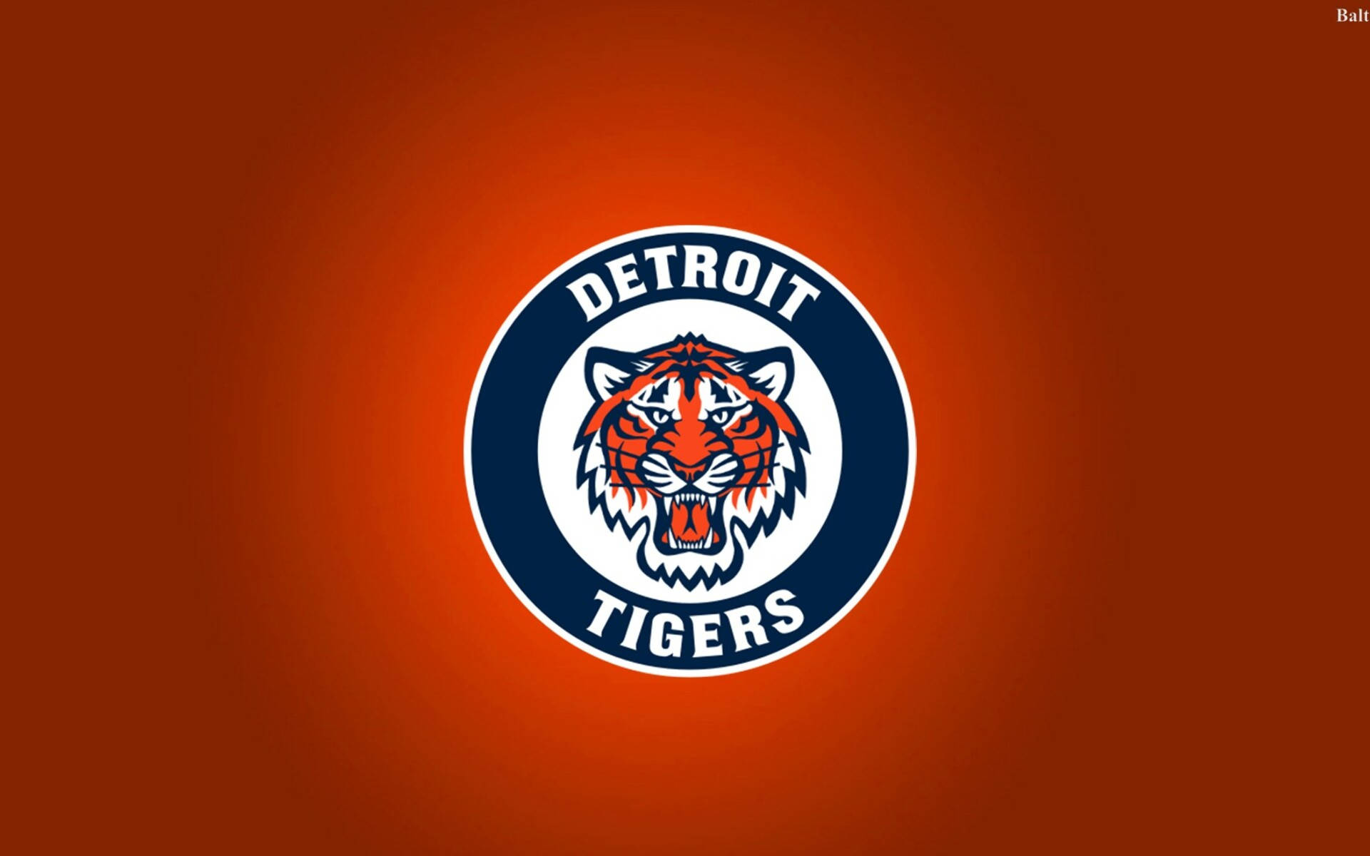 tigers 桌布 壁紙 — 一個大膽的底特律老虎隊標誌，咆哮的老虎頭部居中在橙色漸變背景上。