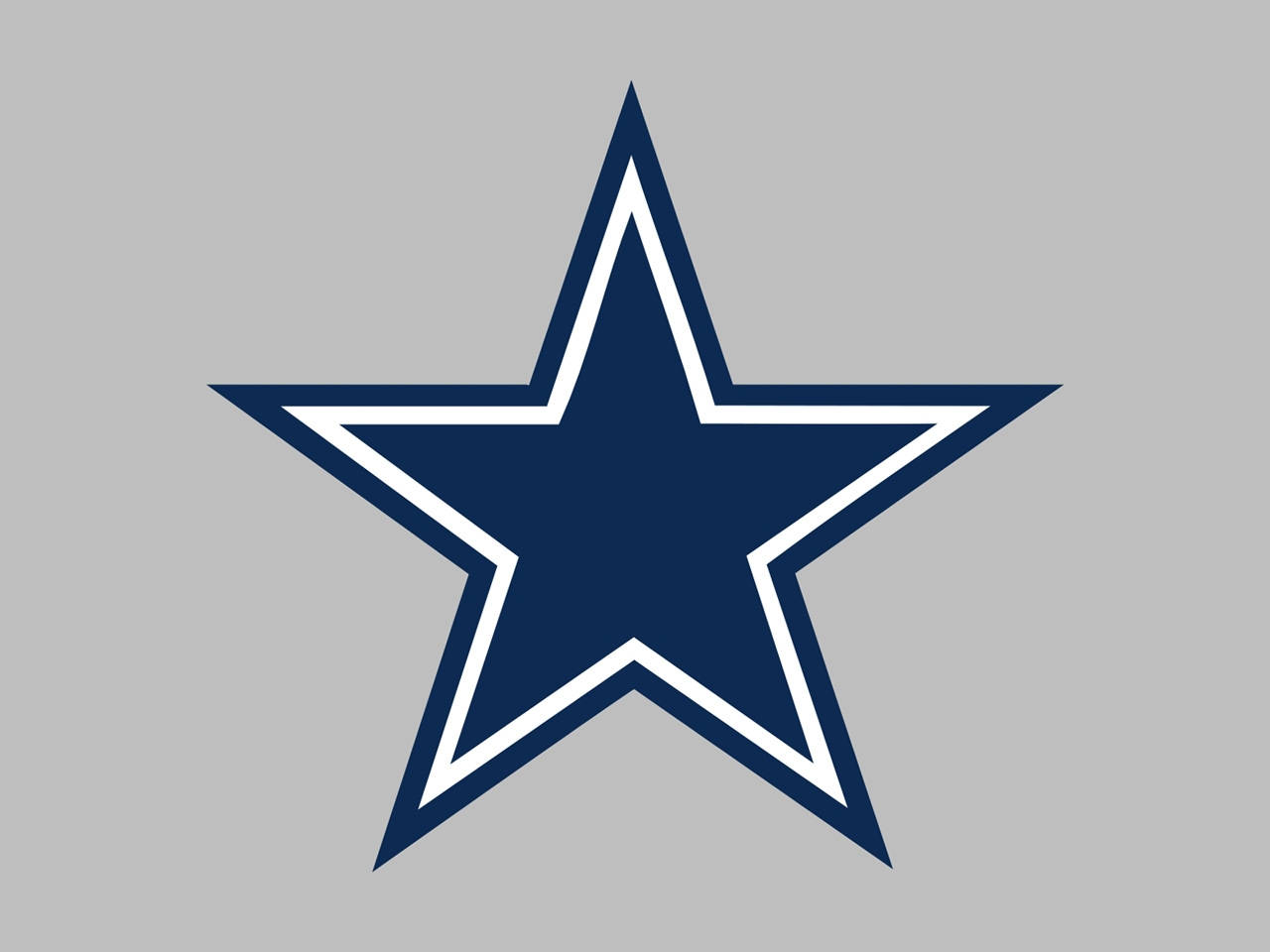 Dallas Cowboys Logo 桌布 壁紙 — 一個大膽的海軍藍星星，帶有白色輪廓，居中在純灰色背景上。