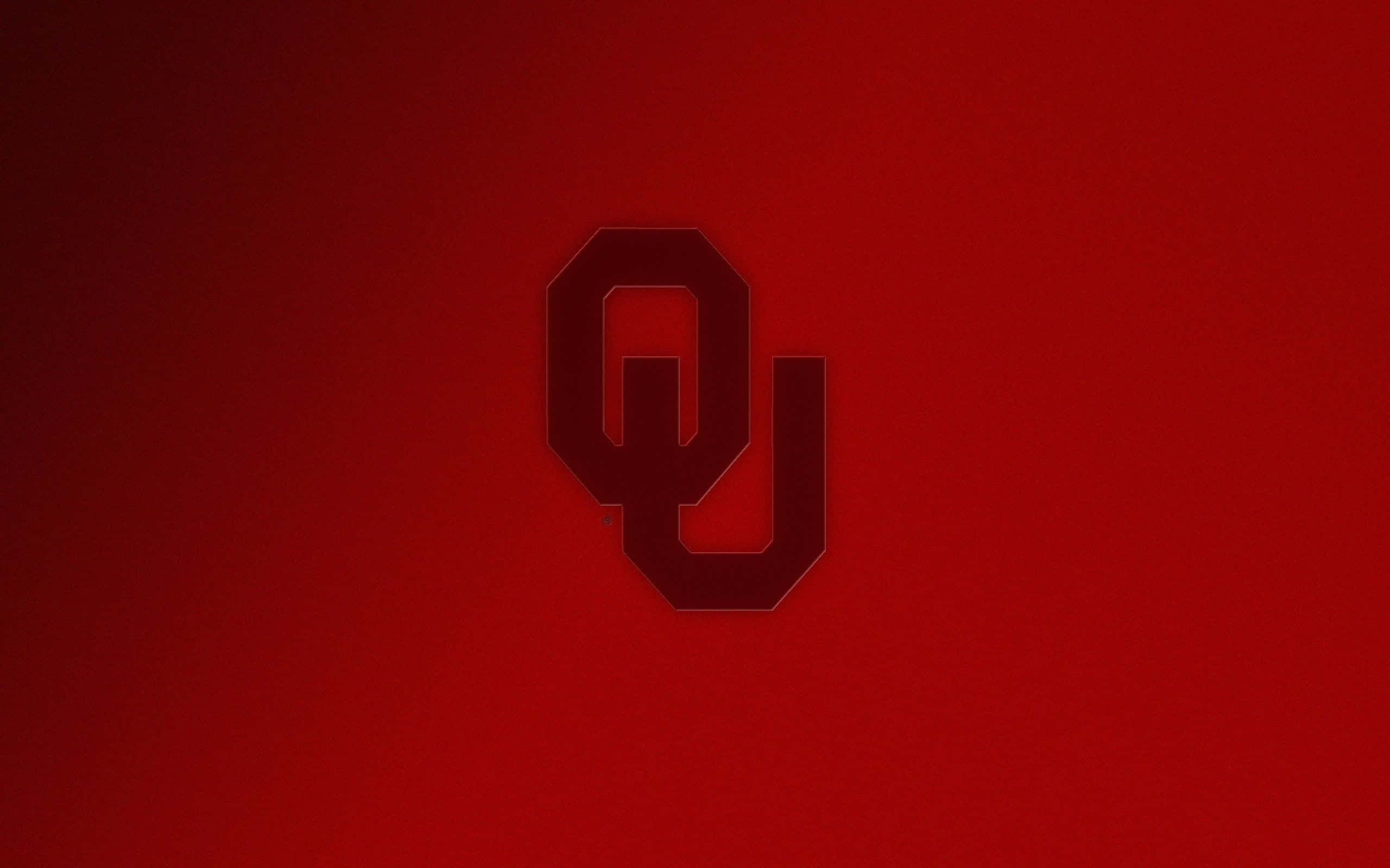 Oklahoma 桌布 壁紙 — 一個大膽的深紅色 OU 標誌居中在漸變紅色背景上，帶有微妙的燈光效果。