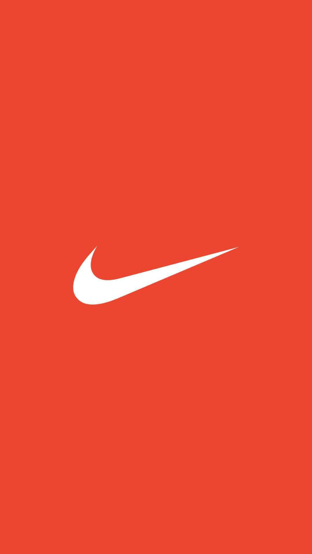 Red Nike 桌布 壁紙 — 一個大膽的白色Nike swoosh標誌居中在純色鮮豔的橙色背景上。