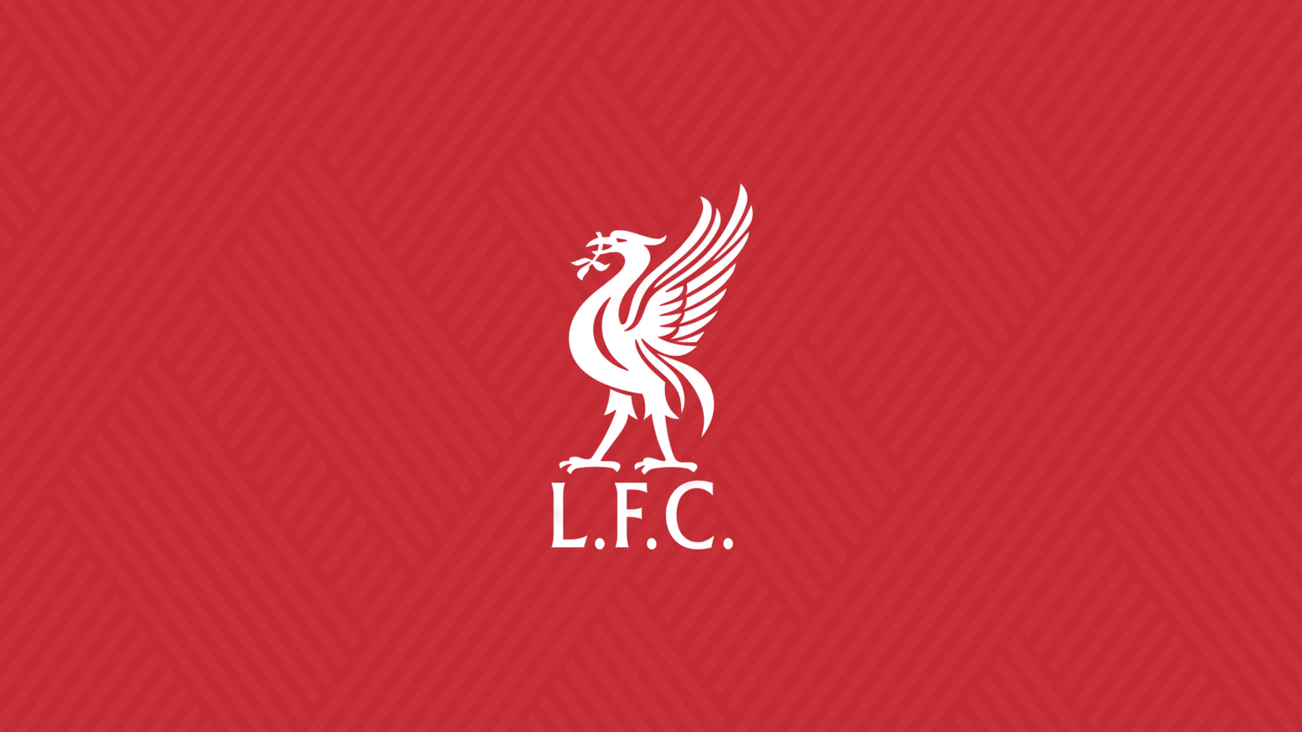 Liverpool Fc Desktop 桌布 壁紙 — 一個大膽的白色利物浦足球俱樂部徽章，帶有翅膀的利物鳥，居中在帶紋理的紅色背景上。
