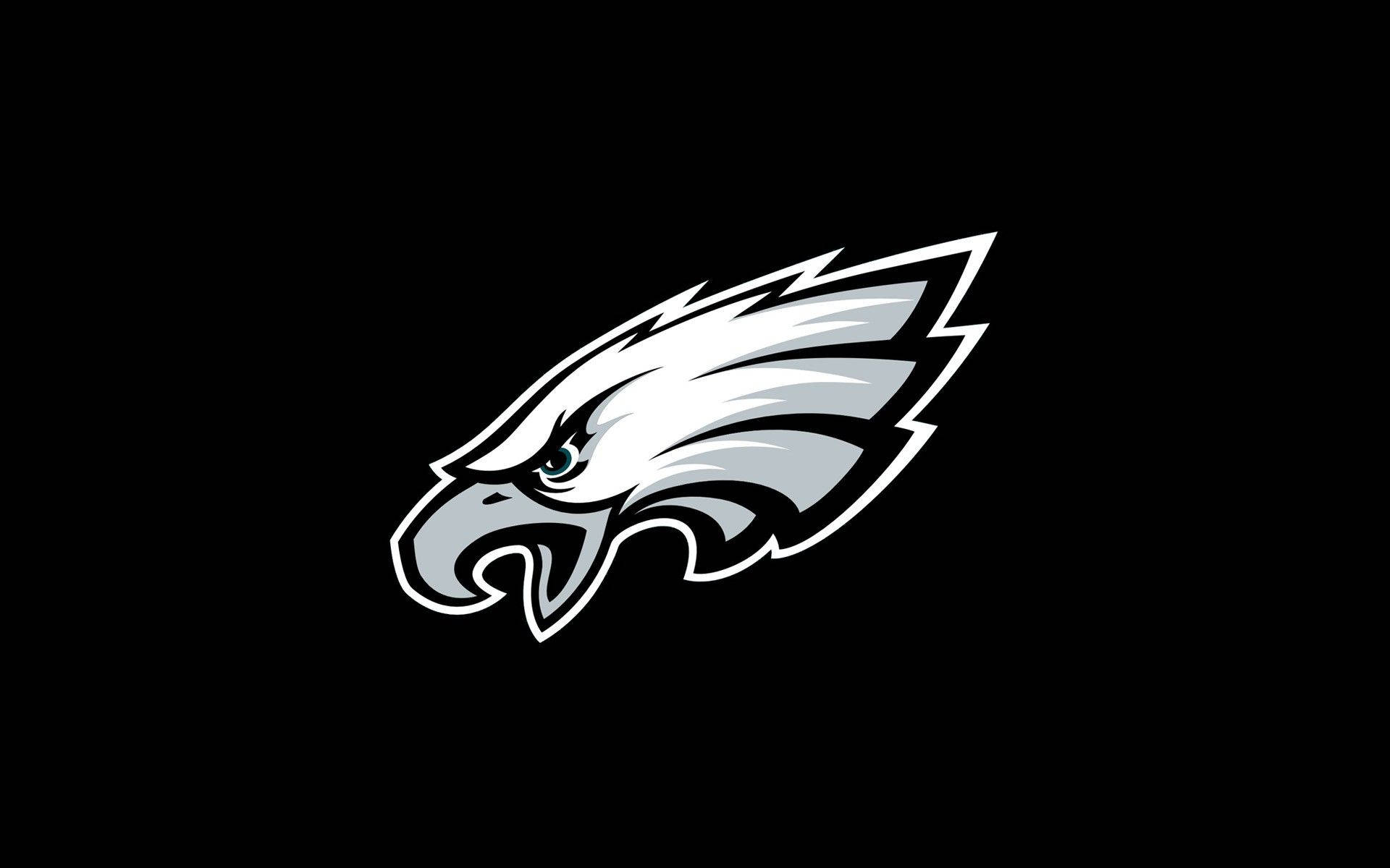 Eagles 桌布 壁紙 — 一個大膽的白色和銀色鷹頭標誌，線條銳利，眼神兇猛，置於純黑色背景上。