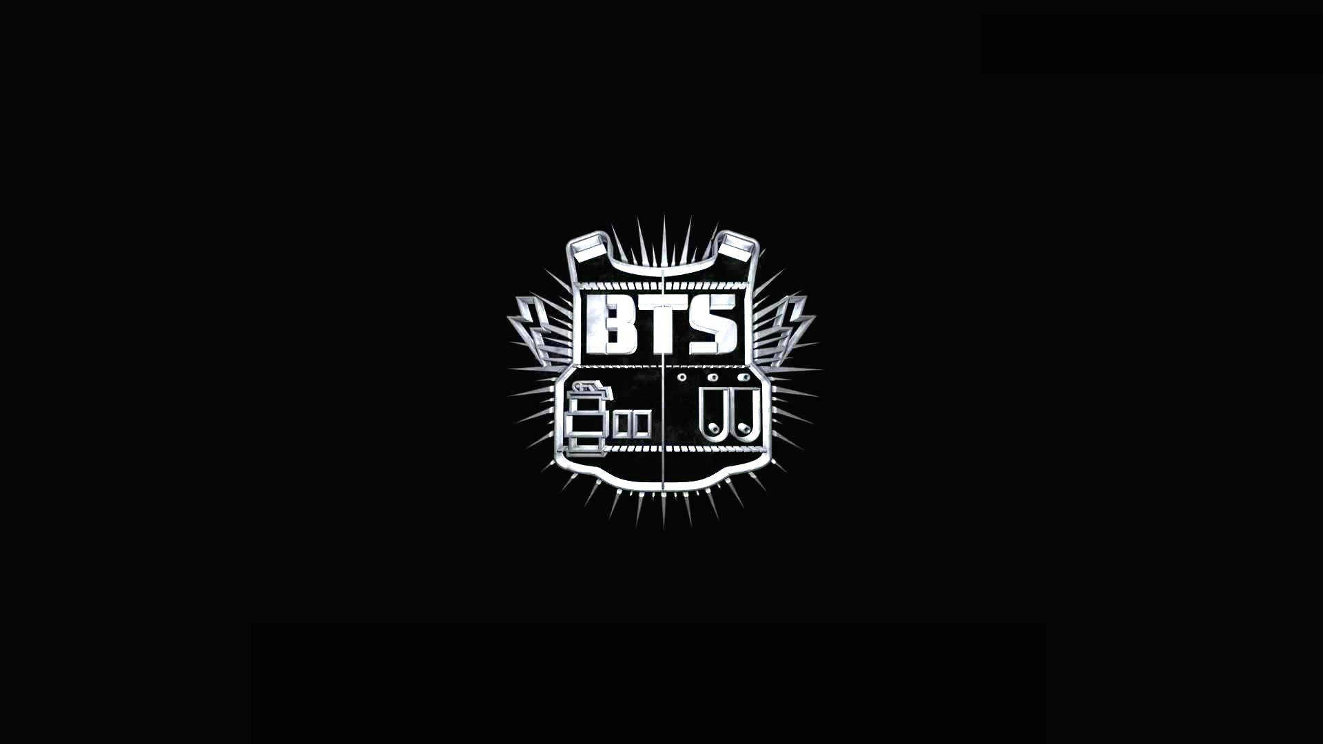 BTS 筆電 桌布 壁紙 — 一個大膽的白色圖形標誌，中央有 'BTS' 粗體字，黑色背景上帶有向外放射的尖刺光線。