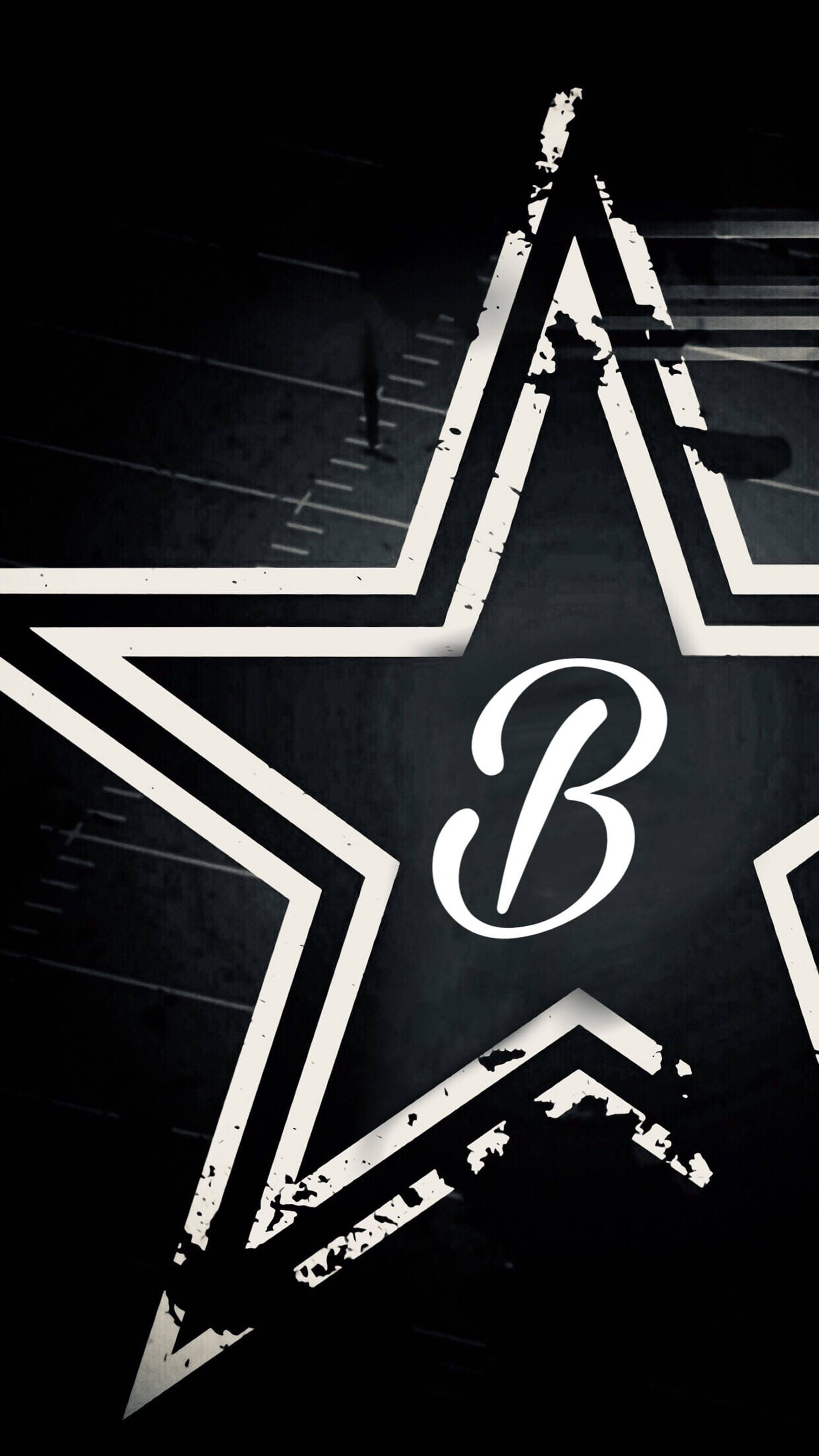 字母B 桌布 壁紙 — 一個大膽的白色星星，中心有一個風格化的「B」，主導著帶有微弱網格線的深色紋理背景。