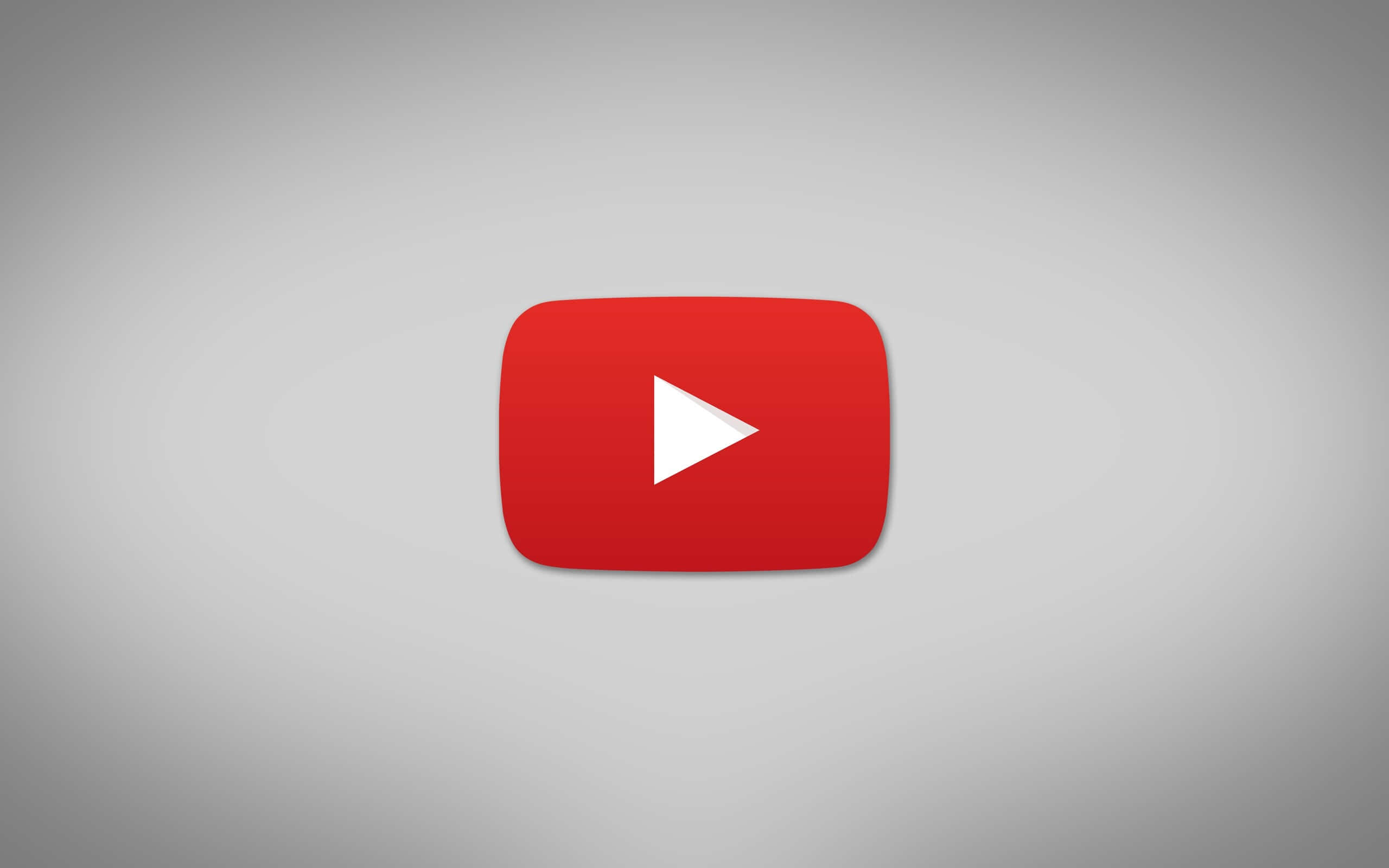 YouTube Logo 桌布 壁紙 — 一個大膽的紅色 YouTube 播放按鈕圖示，居中於柔和的灰色漸變背景上。