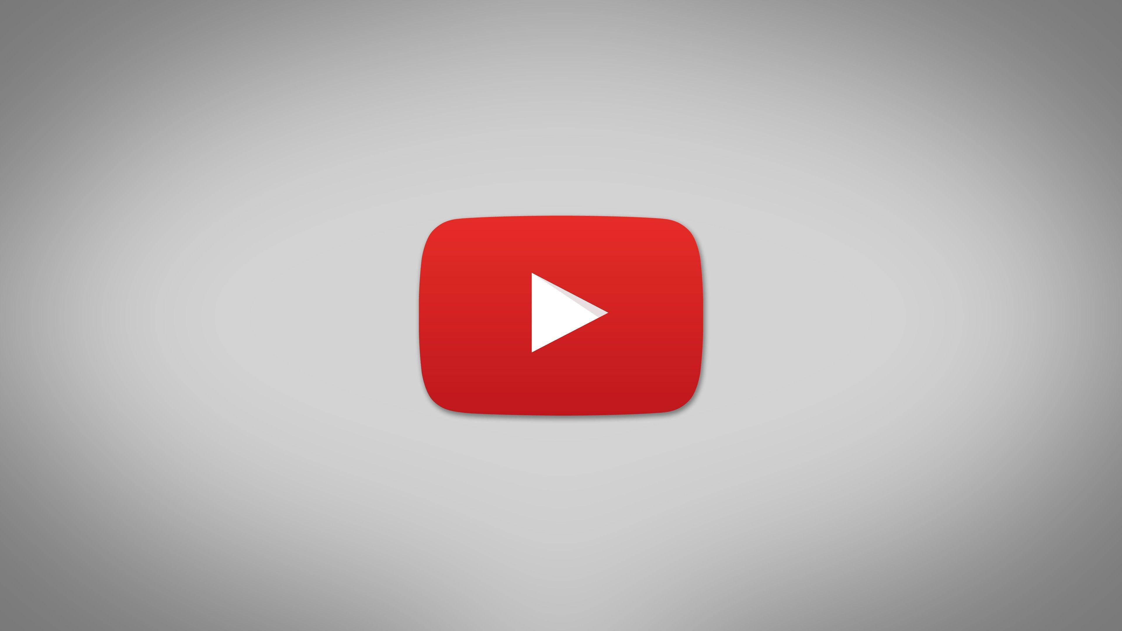 美學 桌布 壁紙 — 一個大膽的紅色 YouTube 播放按鈕圖示，居中在柔和的灰色漸變背景上。