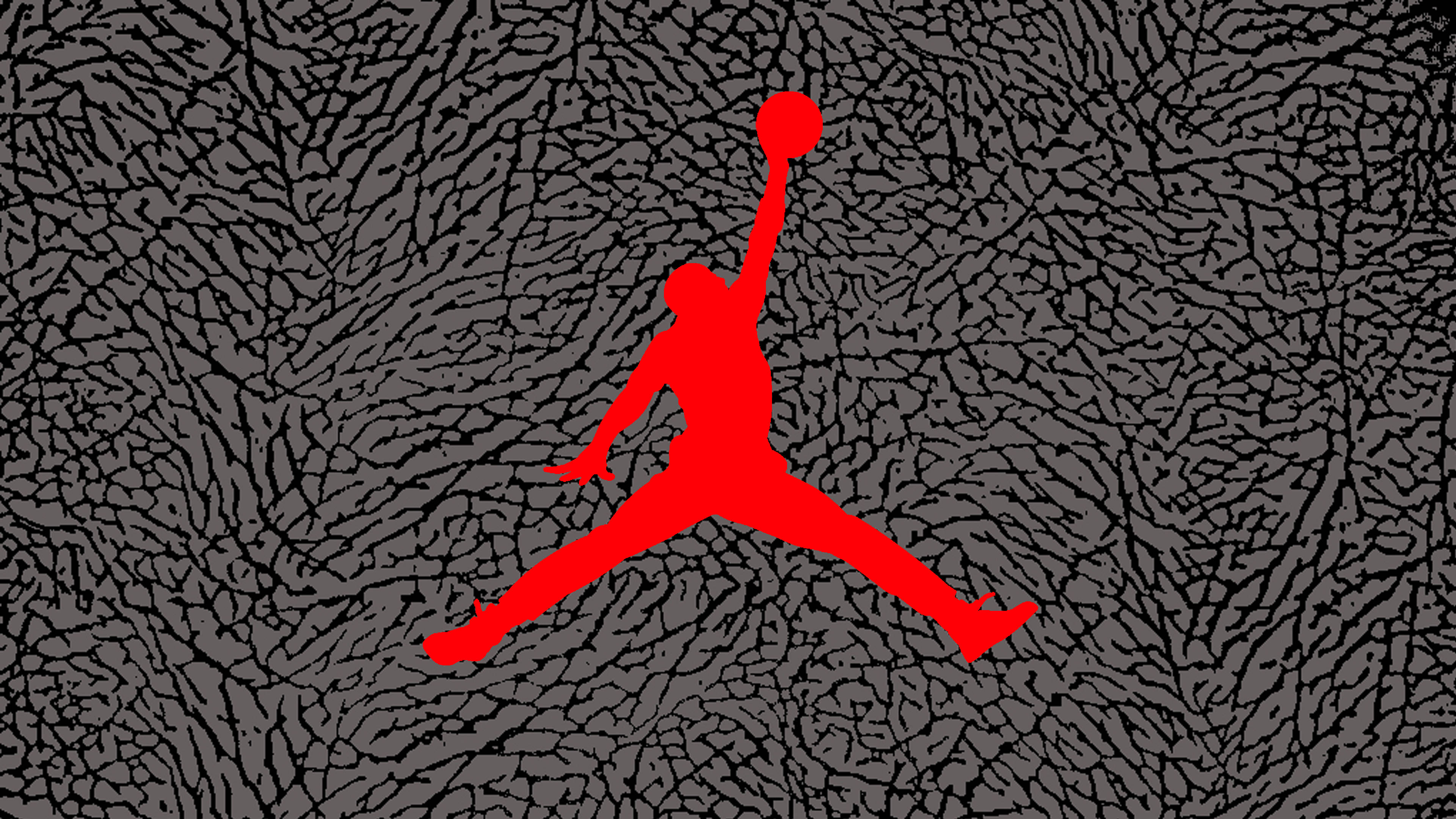 Air Jordan 桌布 壁紙 — 一個大膽的紅色剪影，描繪一名籃球運動員在半空中持球，背景為帶紋理的灰色。