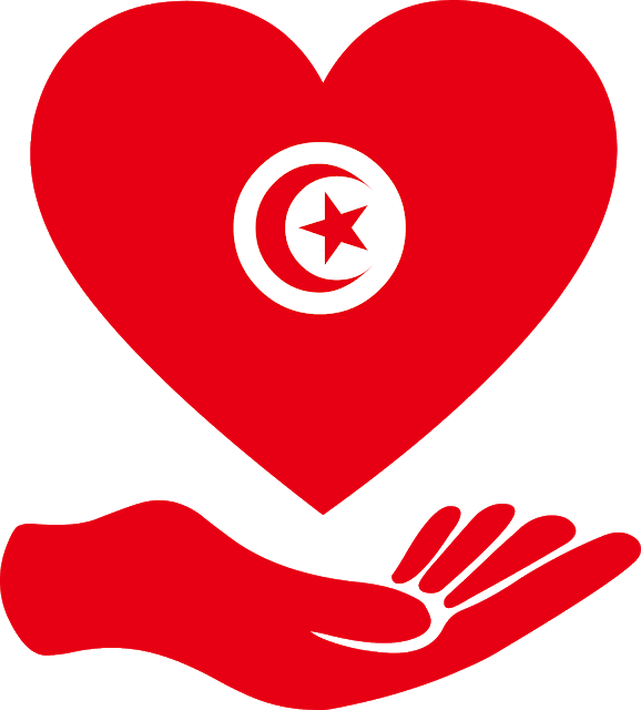 Tunisia 桌布 壁紙 — 一個大膽的紅色心形，帶有突尼斯國旗標誌，由一隻相配的紅色手托著，背景為純黑色。
