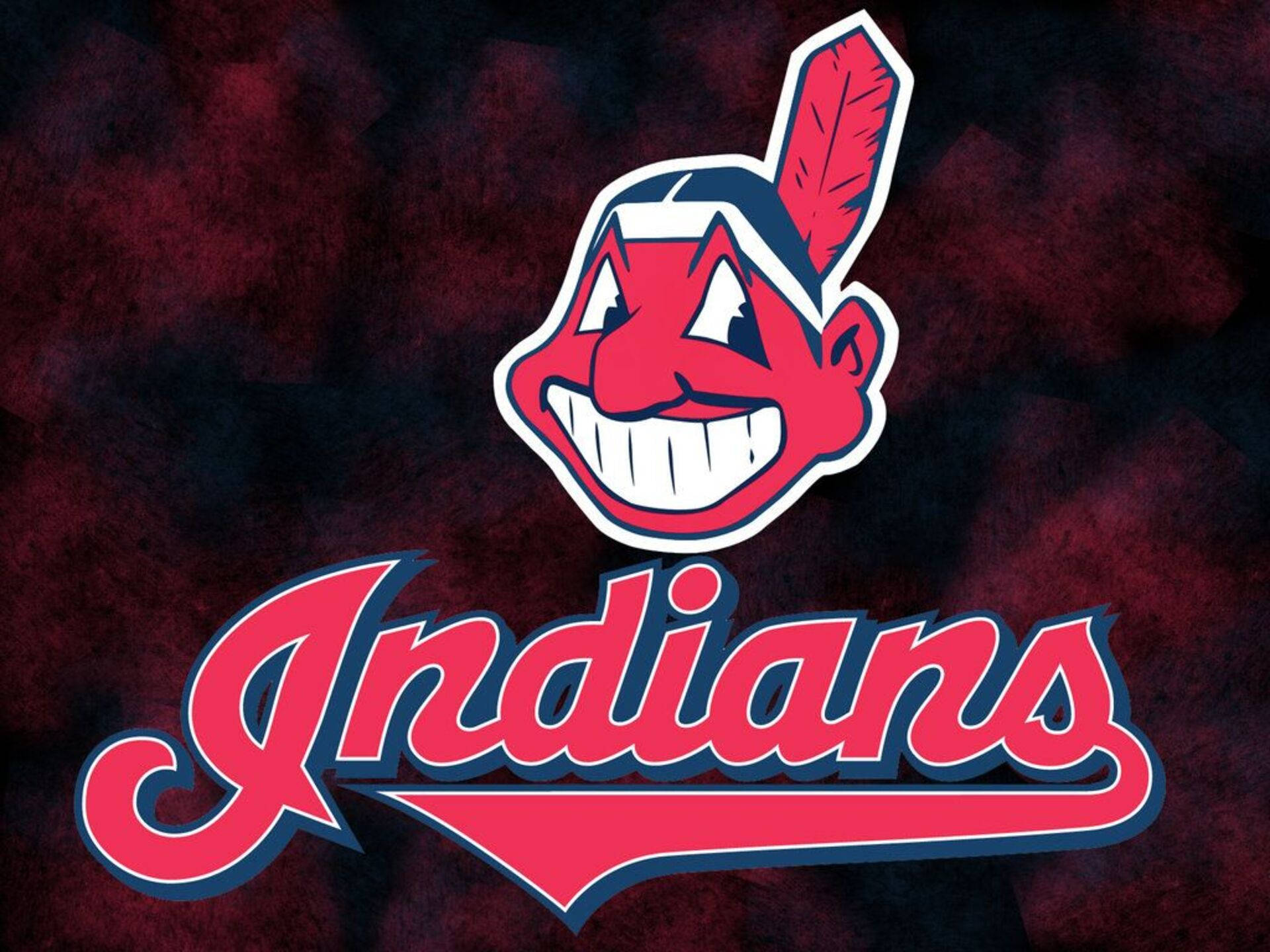 Cleveland Indians 桌布 壁紙 — 一個大膽的紅藍色克里夫蘭印地安人標誌，帶有笑臉和羽毛，背景為深色大理石紋。