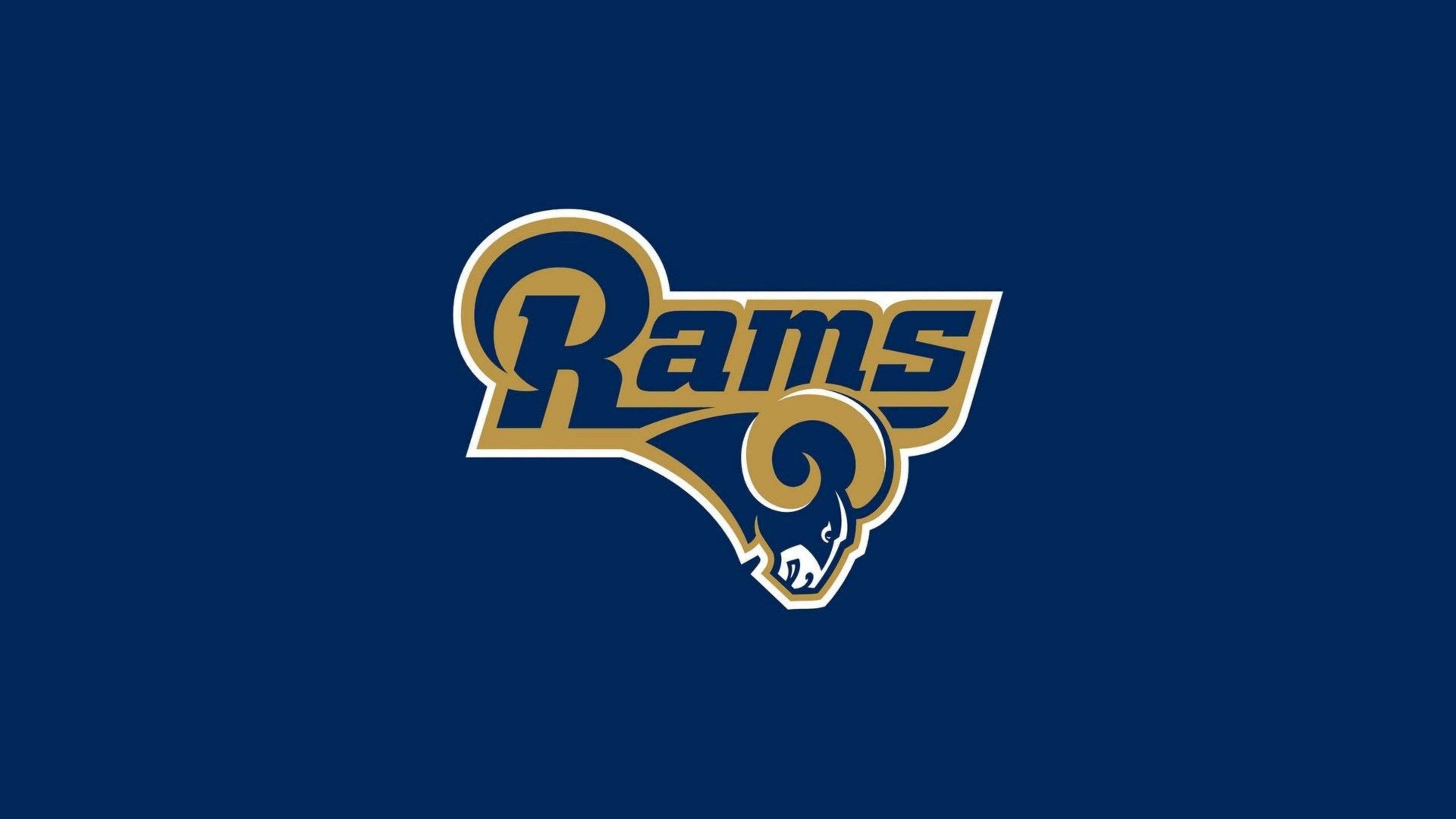 Rams 桌布 壁紙 — 一個大膽的藍色和金色公羊隊標誌居中在純海軍藍背景上。