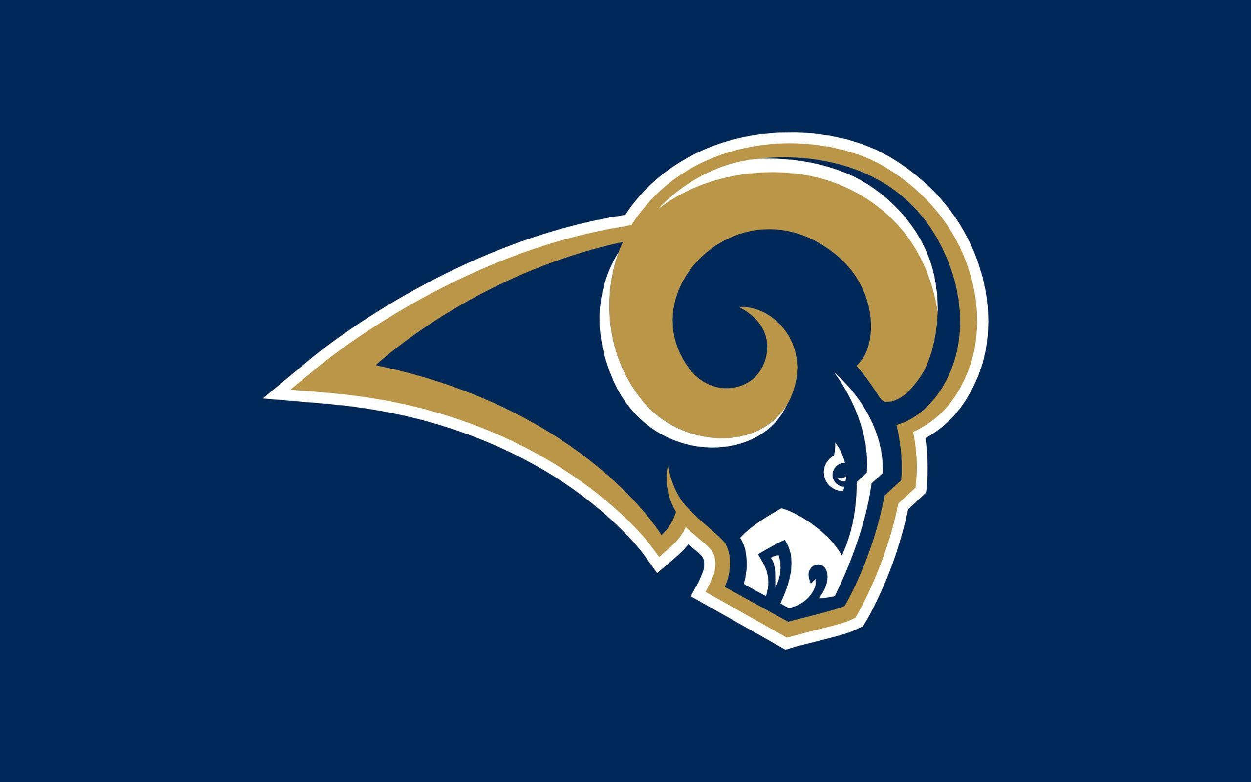 NFL Team Logo 桌布 壁紙 — 一個大膽的金色公羊頭標誌，帶有白色輪廓，置於純海軍藍背景上。