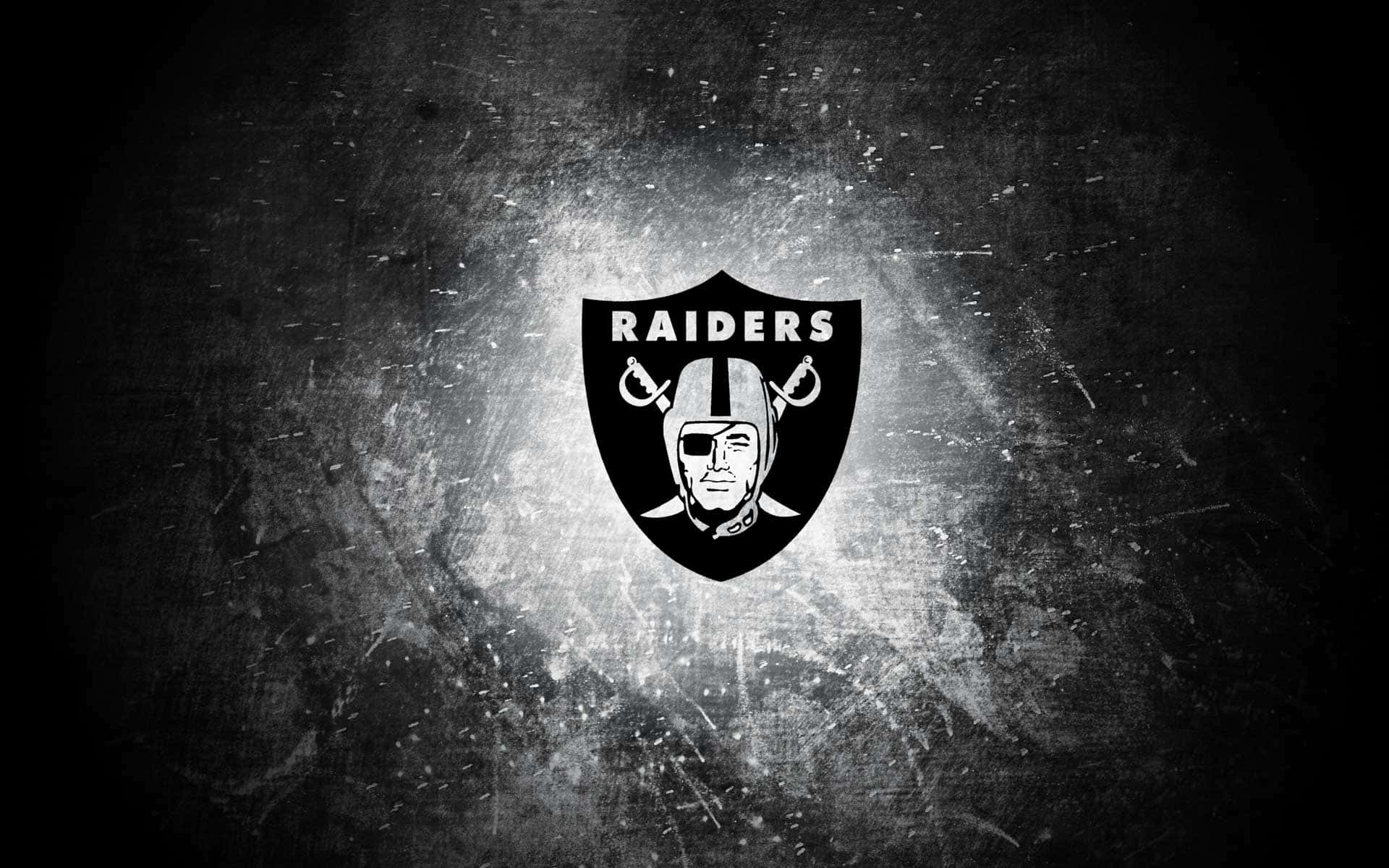 Raiders標誌在帶有光紋的深色紋理背景上。 — 突襲者 GIF 壁紙