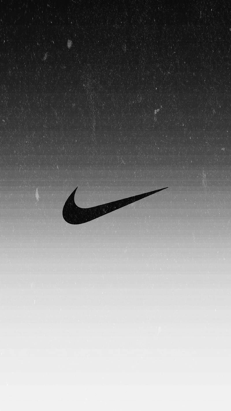 黑色Nike勾勾標誌在帶有紋理的灰階漸變背景上。 — Nike GIF 壁紙
