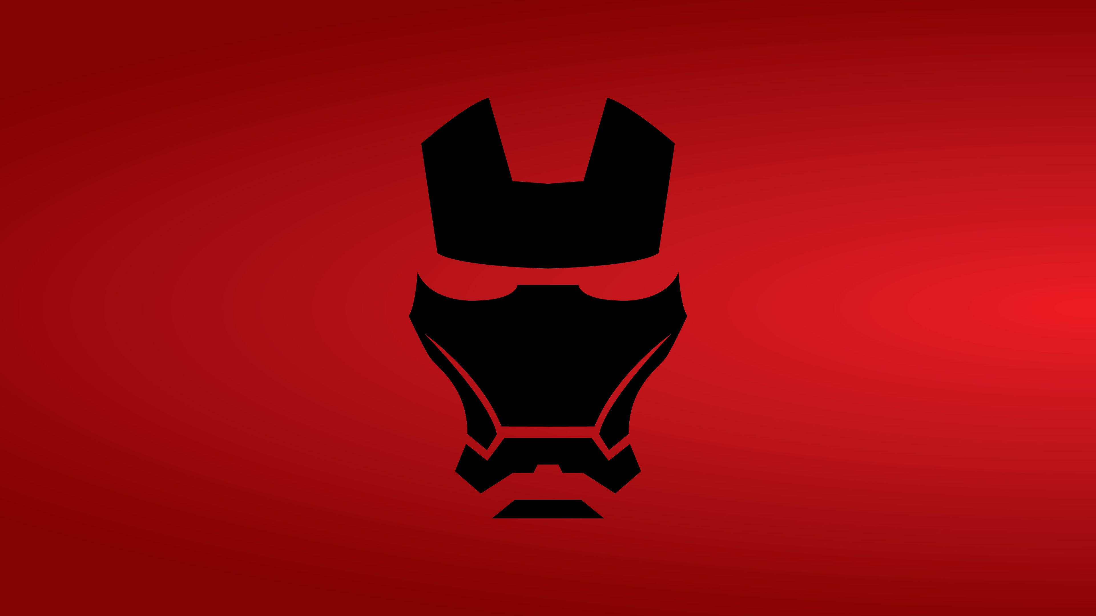 Iron Man Logo 桌布 壁紙 — 一個大膽的黑色鋼鐵人頭盔剪影，居中於漸變紅色背景上。