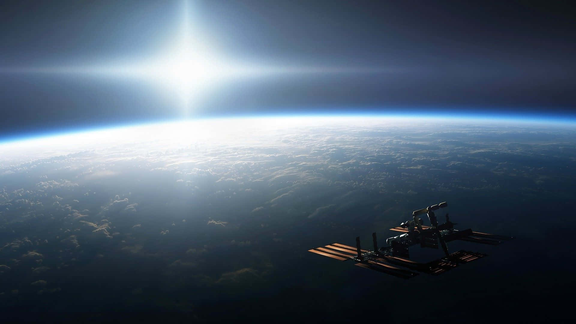 Satellite 桌布 壁紙 — 一個太空站繞地球運行，太陽在行星彎曲的地平線上方燃燒。