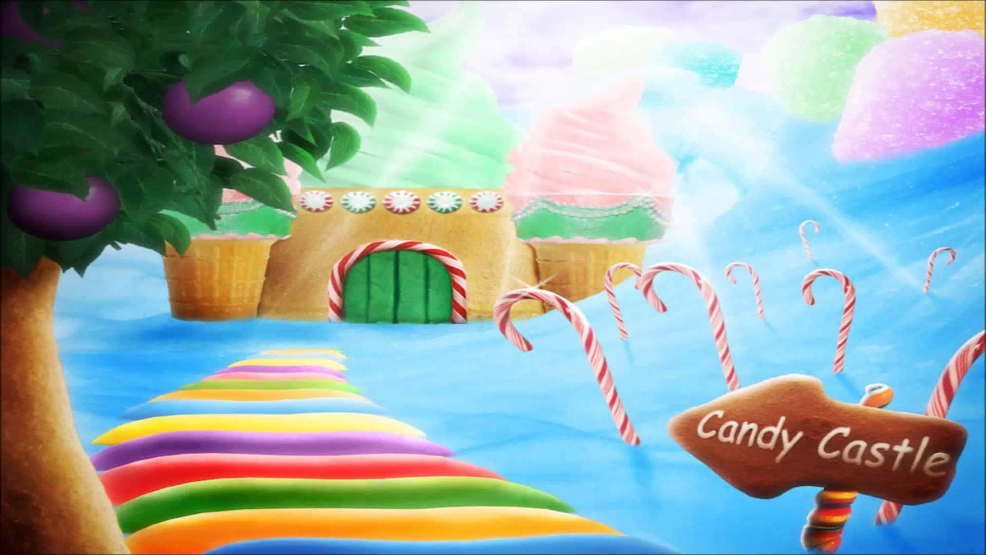 Candy Land 桌布 壁紙 — 一個奇思妙想的糖果主題景觀，有一條彩虹小徑通往一座由冰淇淋和拐杖糖製成的城堡，背景是柔和色調的天空。