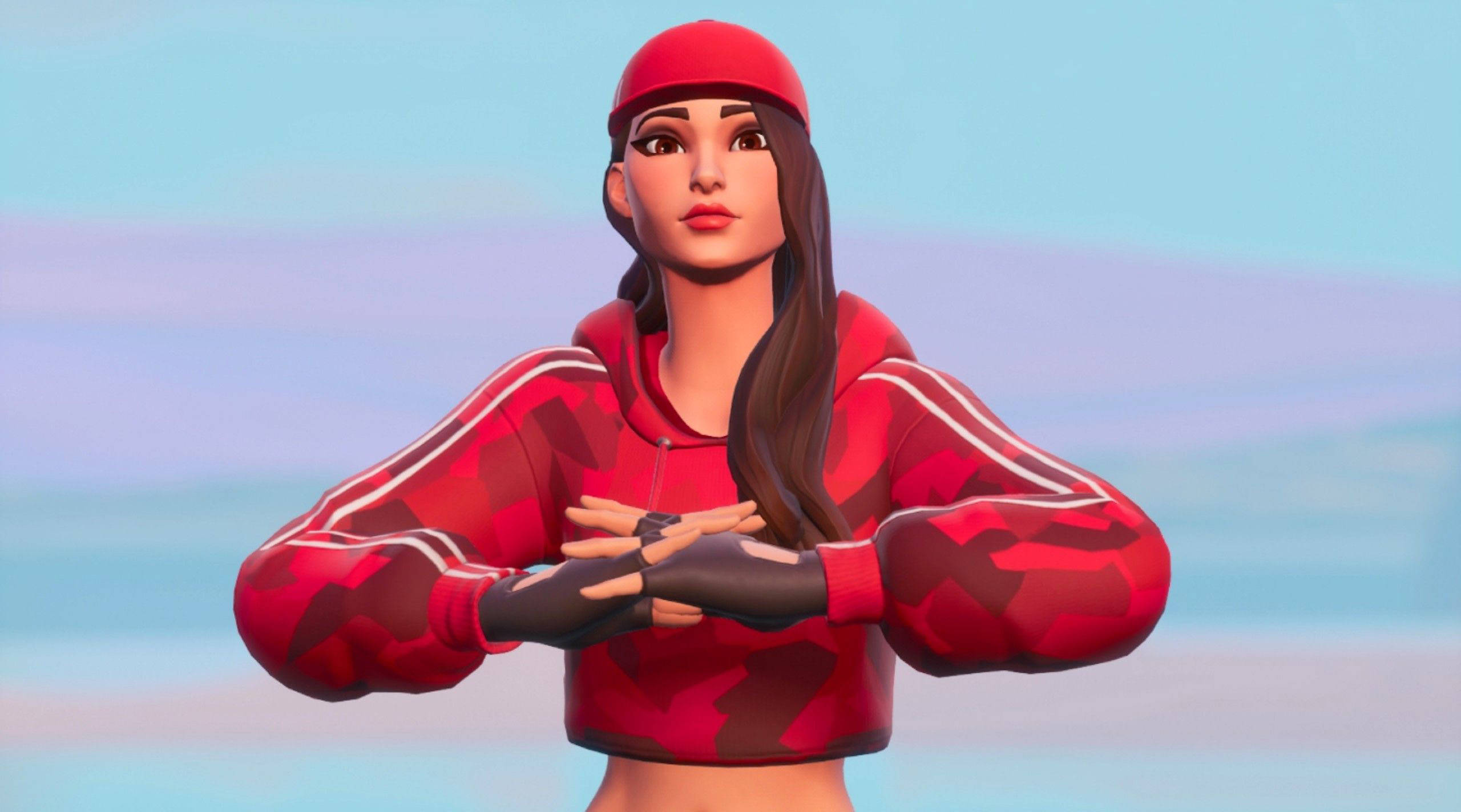 Ruby 桌布 壁紙 — 一個女性Fortnite角色穿著紅色迷彩連帽衫和帽子，雙臂交叉，自信地站在柔和的粉彩天空前。