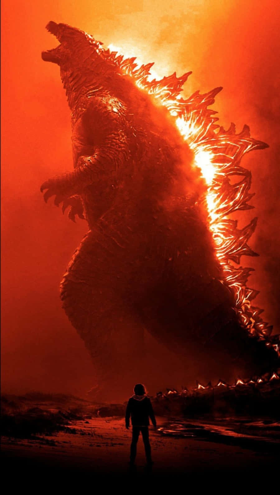 monsters 桌布 壁紙 — 一個孤獨的人站在一個巨大的哥斯拉面前，敬畏地看著它在煙霧彌漫的末日天空中發出火橙色的光芒。