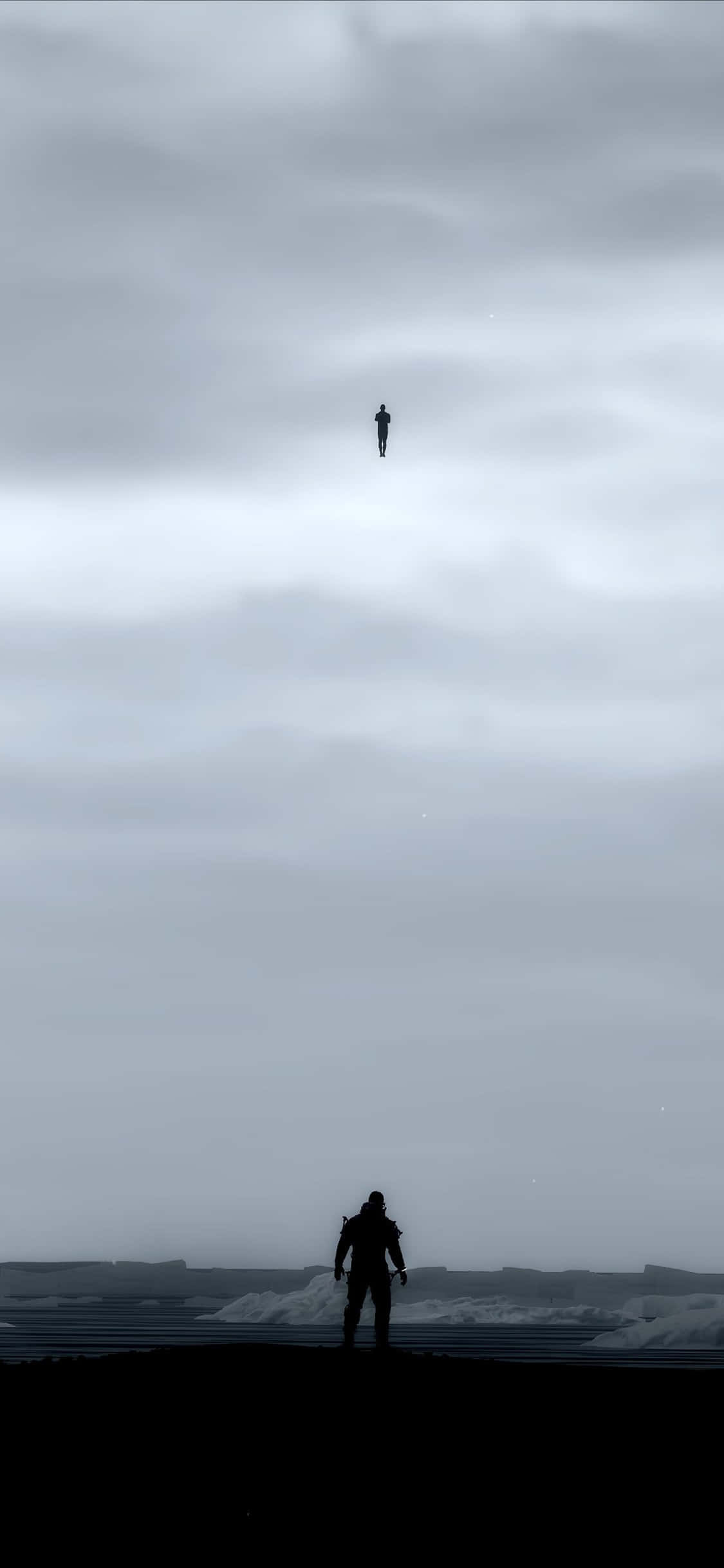 iPhone Xs Death Stranding 桌布 壁紙 — 一個孤獨的剪影站在荒涼的海岸上，仰望另一個漂浮在廣闊陰天中的身影。