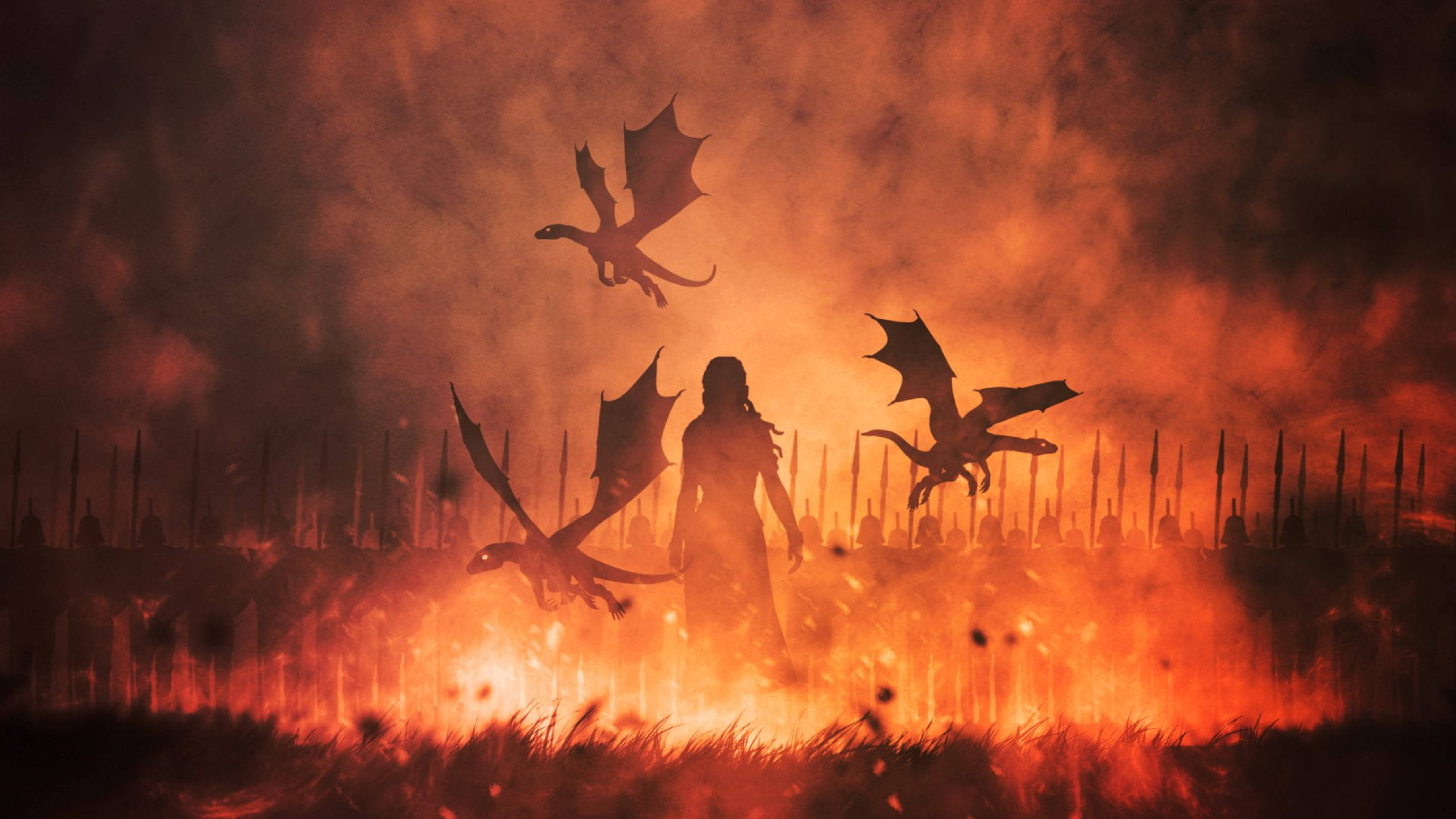 daenerys 桌布 壁紙 — 一個孤獨的戰士站在熊熊烈火中，三條龍在煙霧瀰漫的橙色天空中翱翔，下方是佈滿尖刺的戰場。