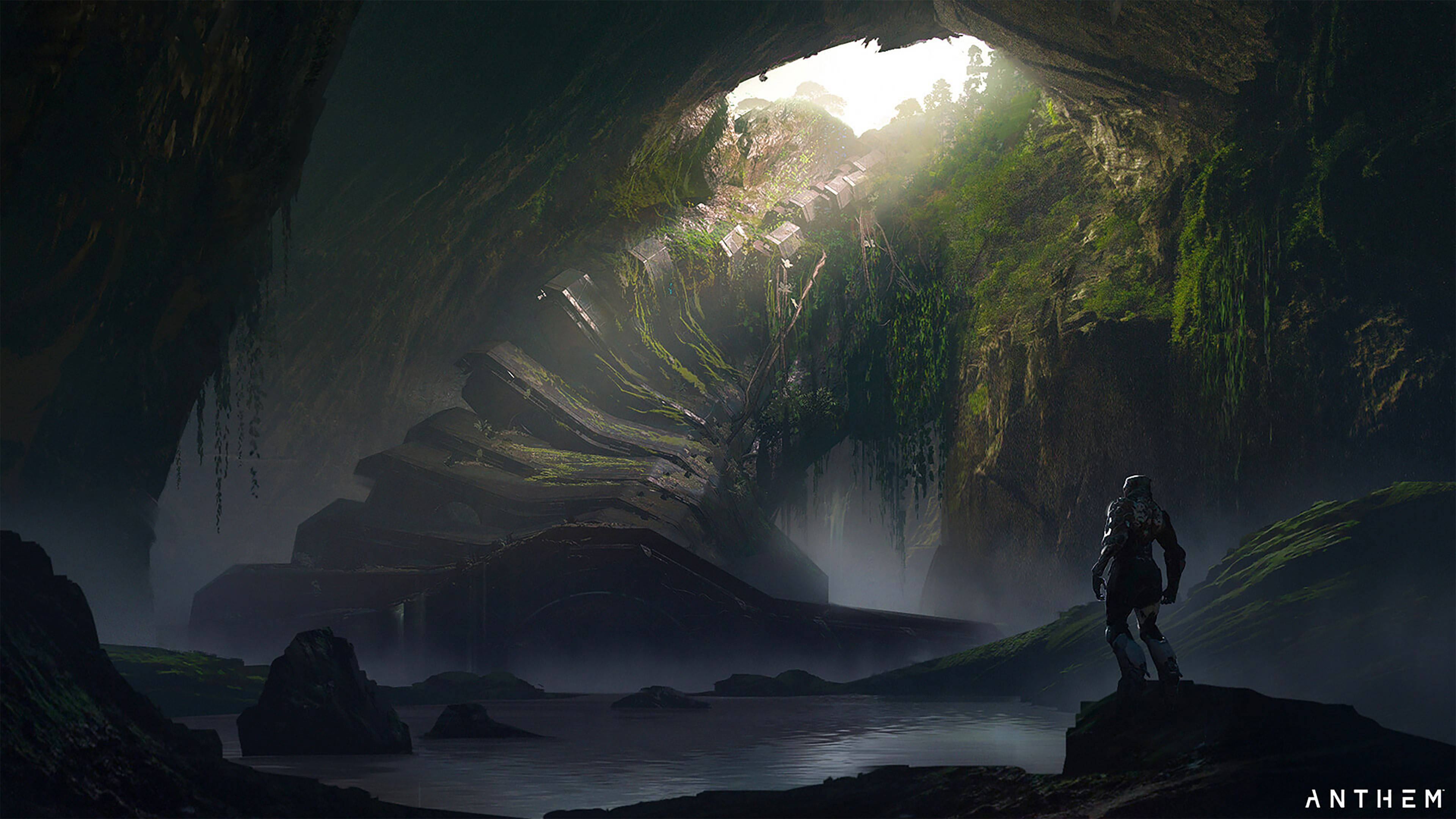 anthem 4K 桌布 壁紙 — 一個孤獨的裝甲人物站在一個廣闊的長滿苔蘚的洞穴內的岩石露頭上，陽光從上方的開口傾瀉而入。