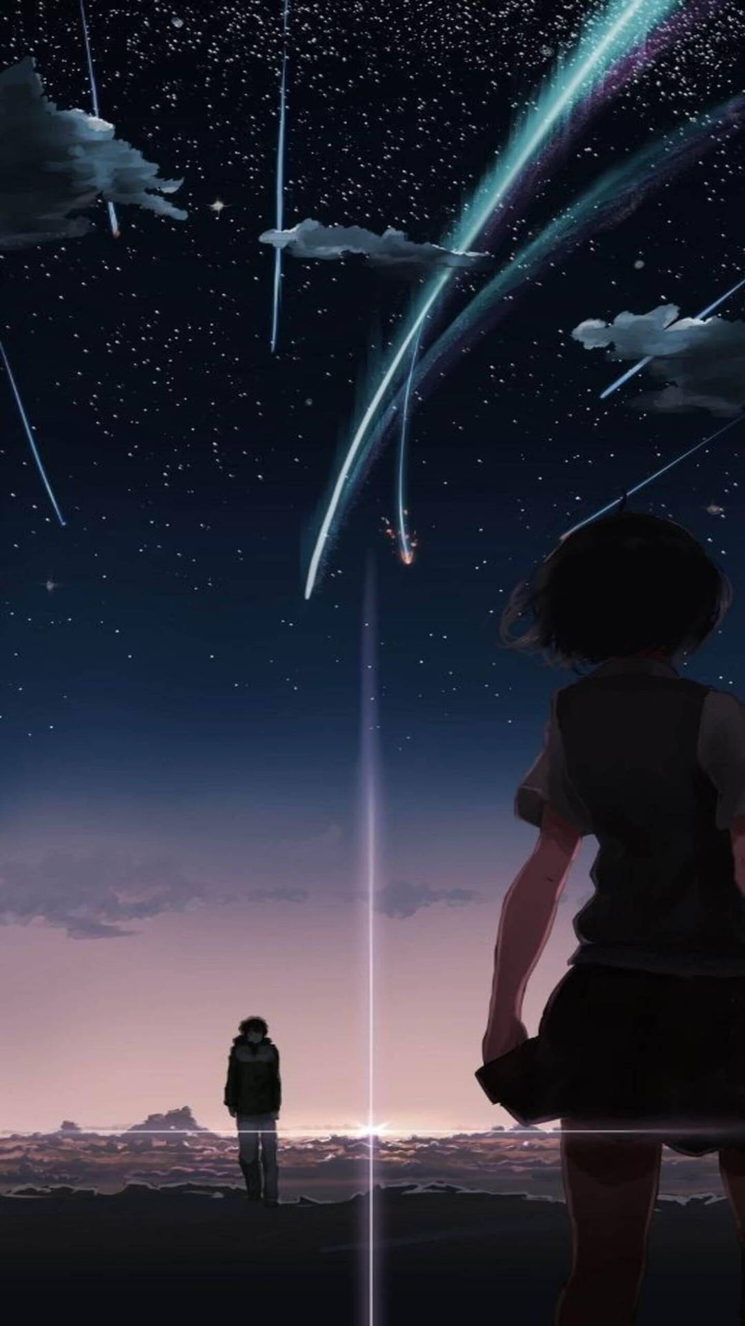 兩個身影站在暮色中充滿流星和星星的天空下。