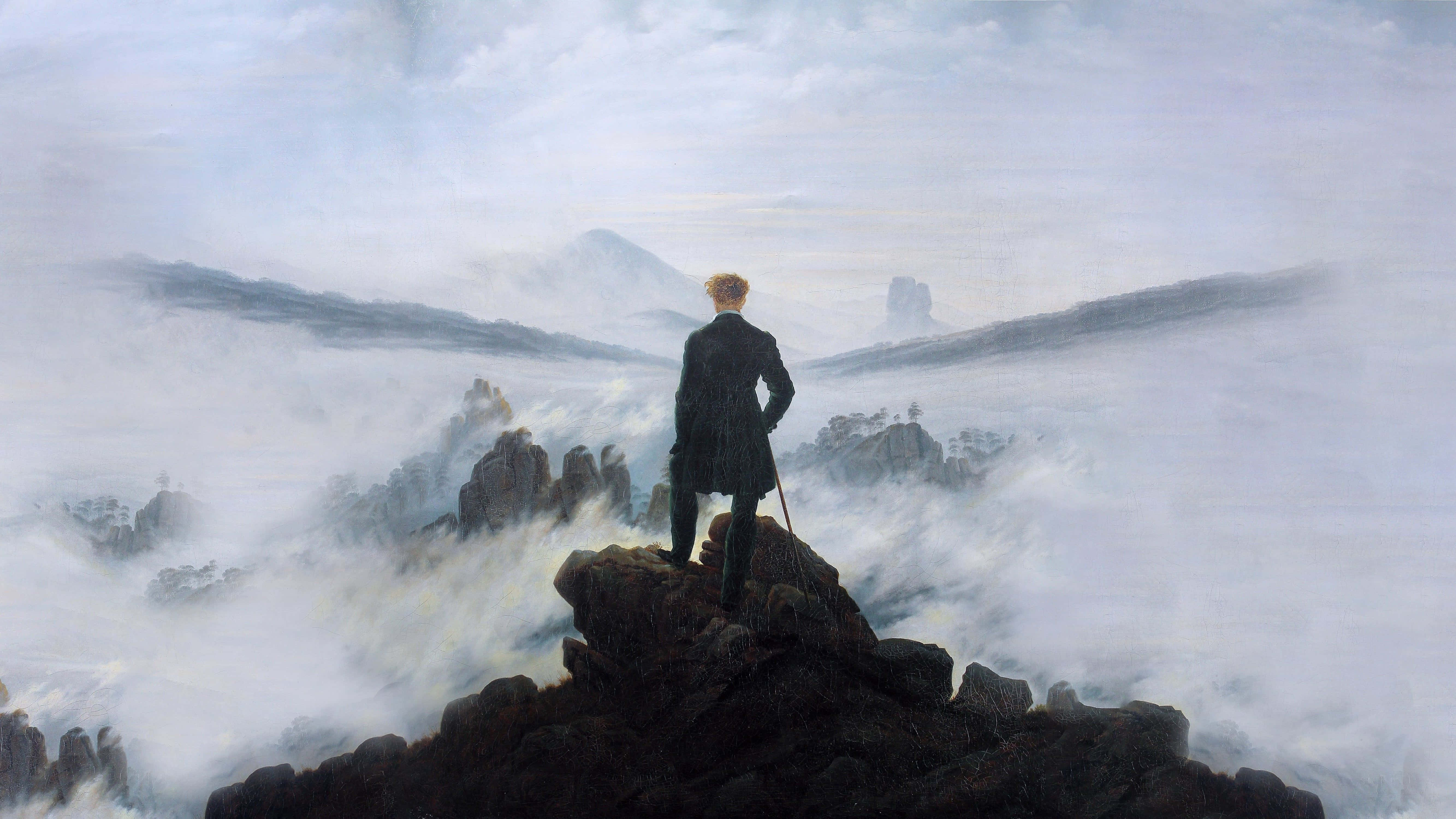 Romanticism 桌布 壁紙 — 一個孤獨的身影穿著深色外套，站在岩石山頂上，俯瞰雲海，遠山在雲層中浮現。