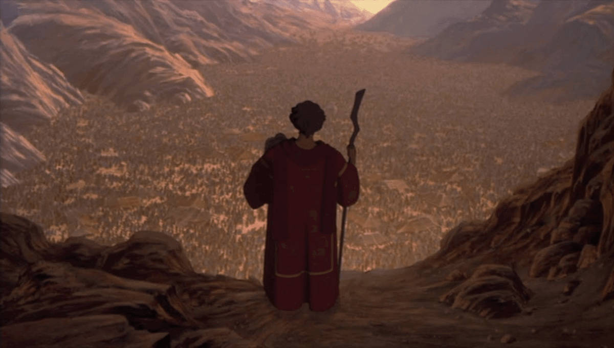 The Prince Of Egypt 桌布 壁紙 — 一個孤獨的長袍身影站在懸崖邊緣，俯瞰著沐浴在溫暖金色光芒中的廣闊峽谷山谷。