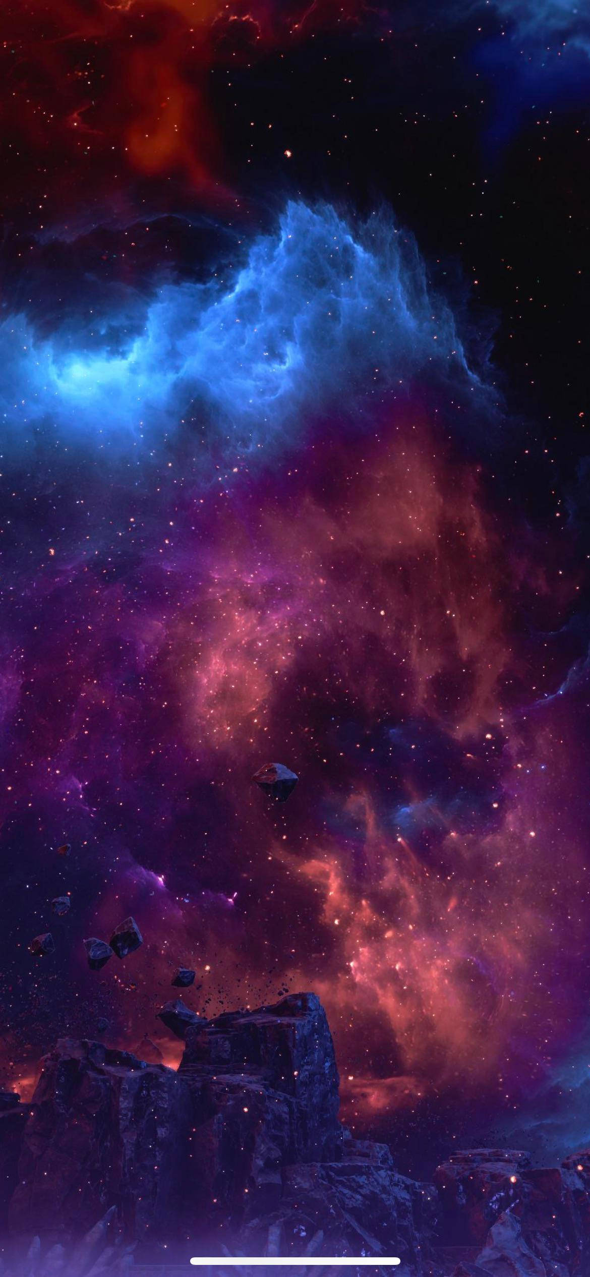 Interesting iPhone 桌布 壁紙 — 一個宇宙星雲，帶有旋轉的藍色和紅色雲朵，漂浮在星空下鋸齒狀的外星岩石上方。