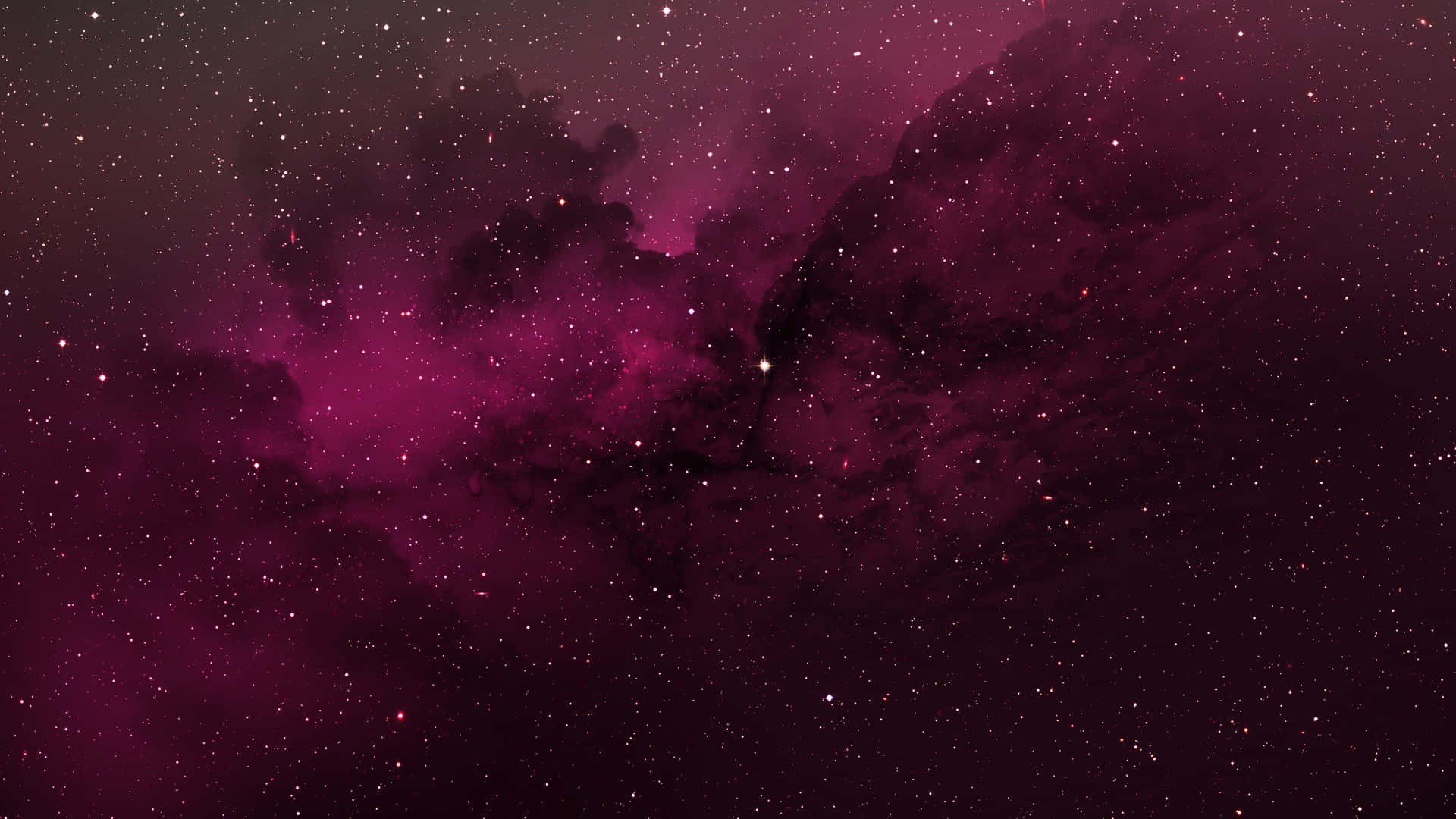 銀河 桌布 壁紙 — 一個宇宙星雲在深洋紅色和黑色中旋轉，散落的星星在虛空中柔和地發光。