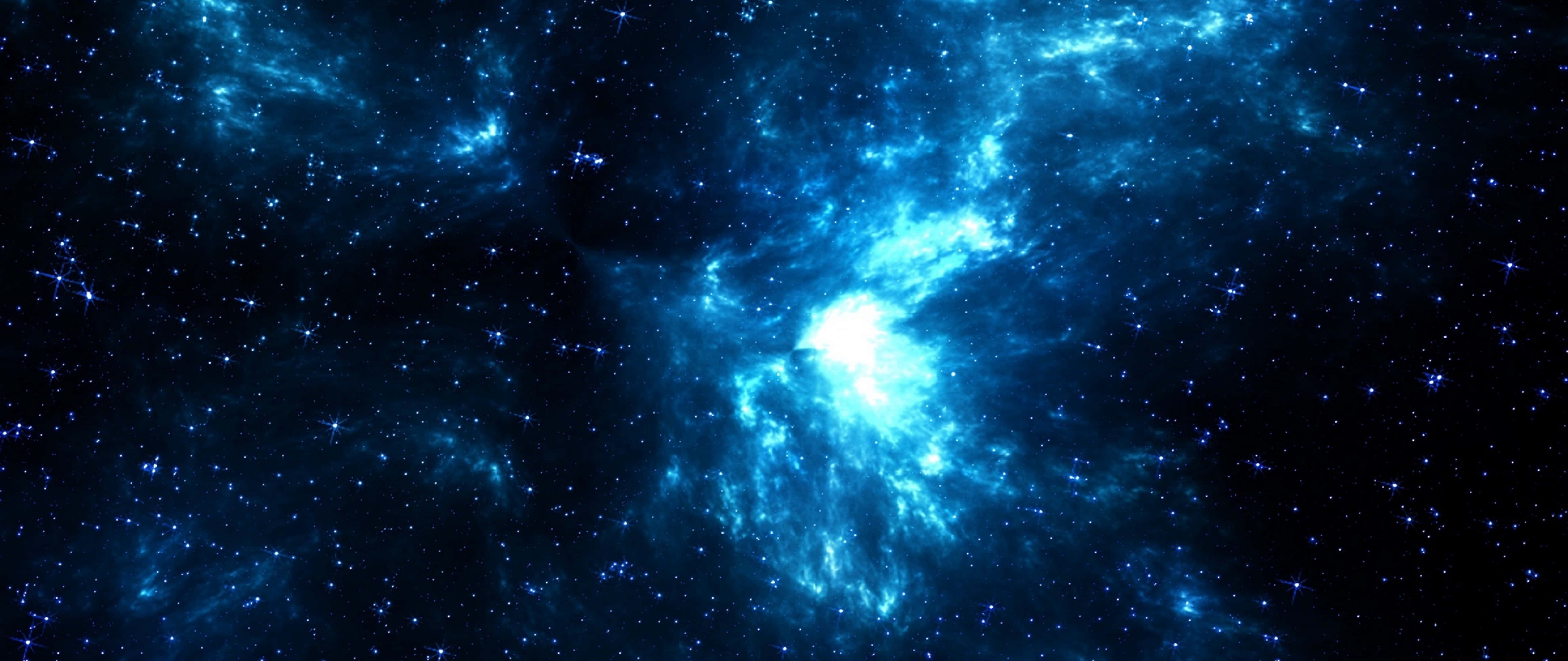 桌布 壁紙 — 一個宇宙星雲在深空的星場背景下發出電藍色和白色的光芒。