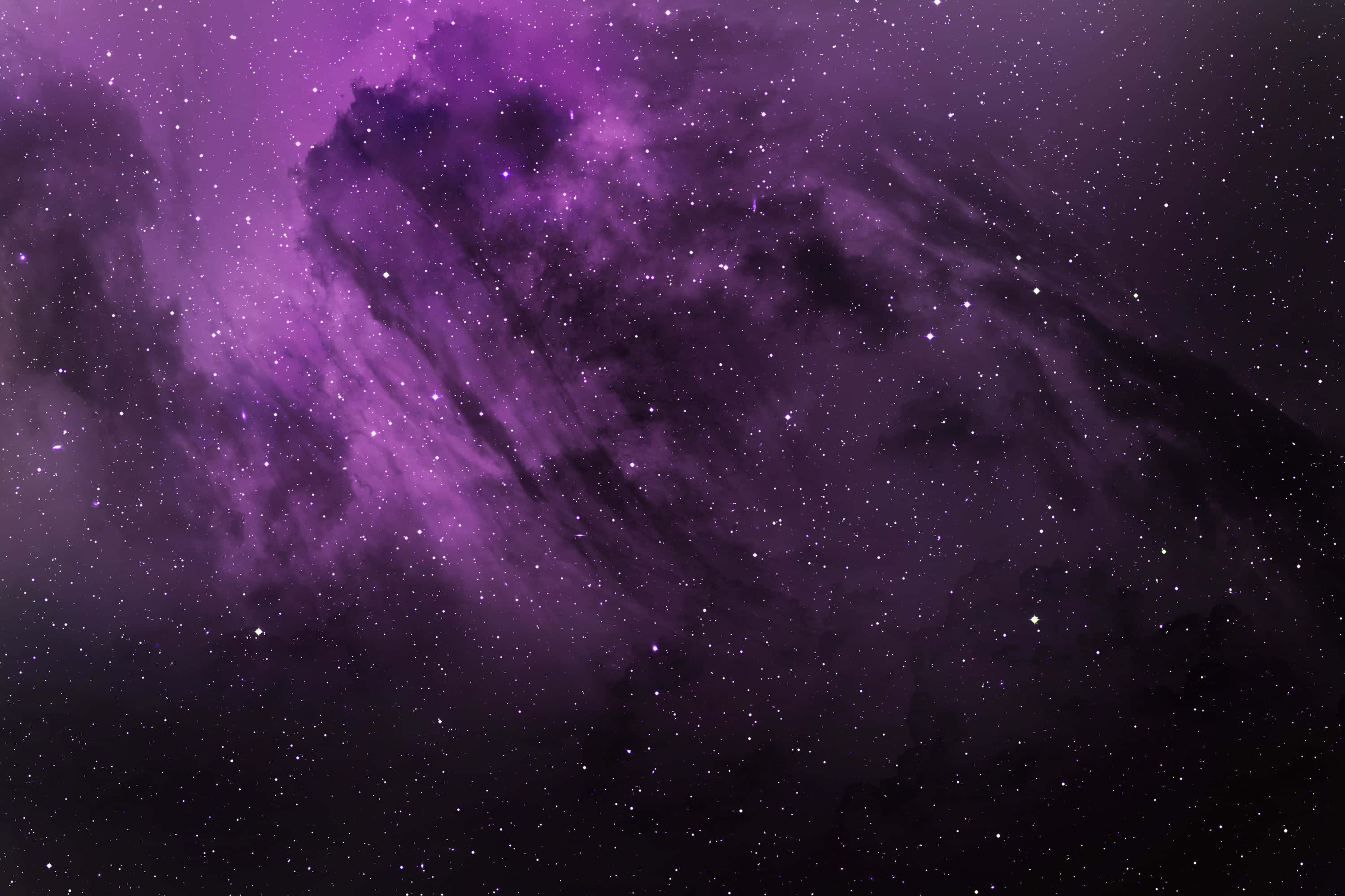 Real Galaxy 桌布 壁紙 — 一個宇宙星雲在深紫色和黑色中旋轉，散落的星星在虛空中柔和地發光。