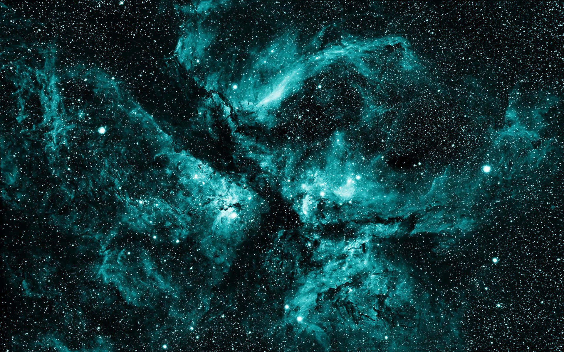 外太空 桌布 壁紙 — 一個宇宙星雲在深藍綠色和黑色中旋轉，發光的星星散落在虛空中。