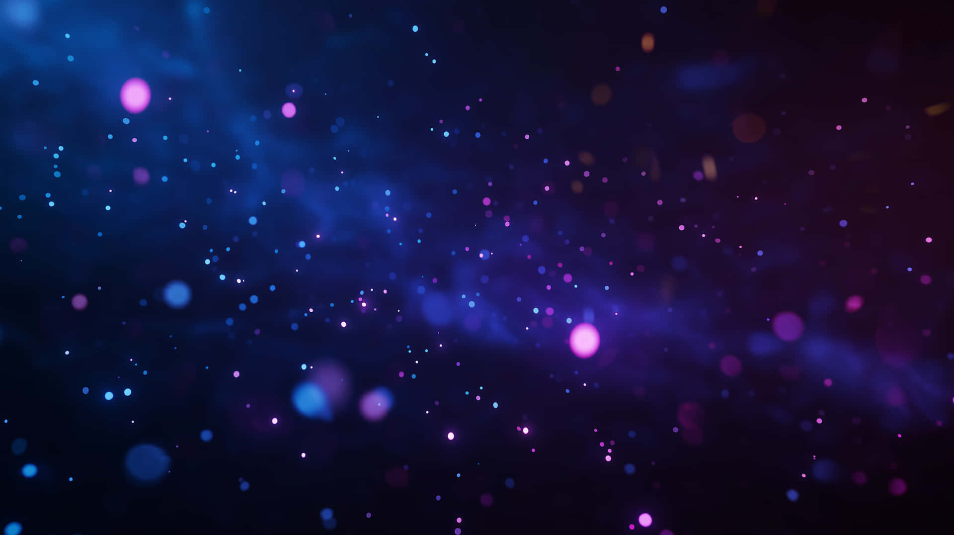 Luminescent Particles in Abstract Blue Purple Light Field 壁紙 — 一個宇宙星雲在黑暗虛空中旋轉，閃爍著藍色和紫色的星星。