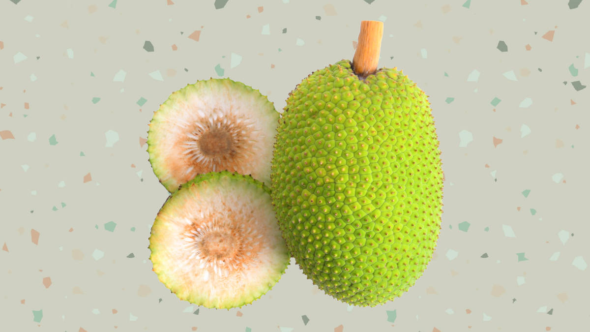 Fruits 桌布 壁紙 — 一個完整的帶刺綠色波羅蜜旁邊有兩半，露出淡奶油色的果肉，背景是斑點水磨石。