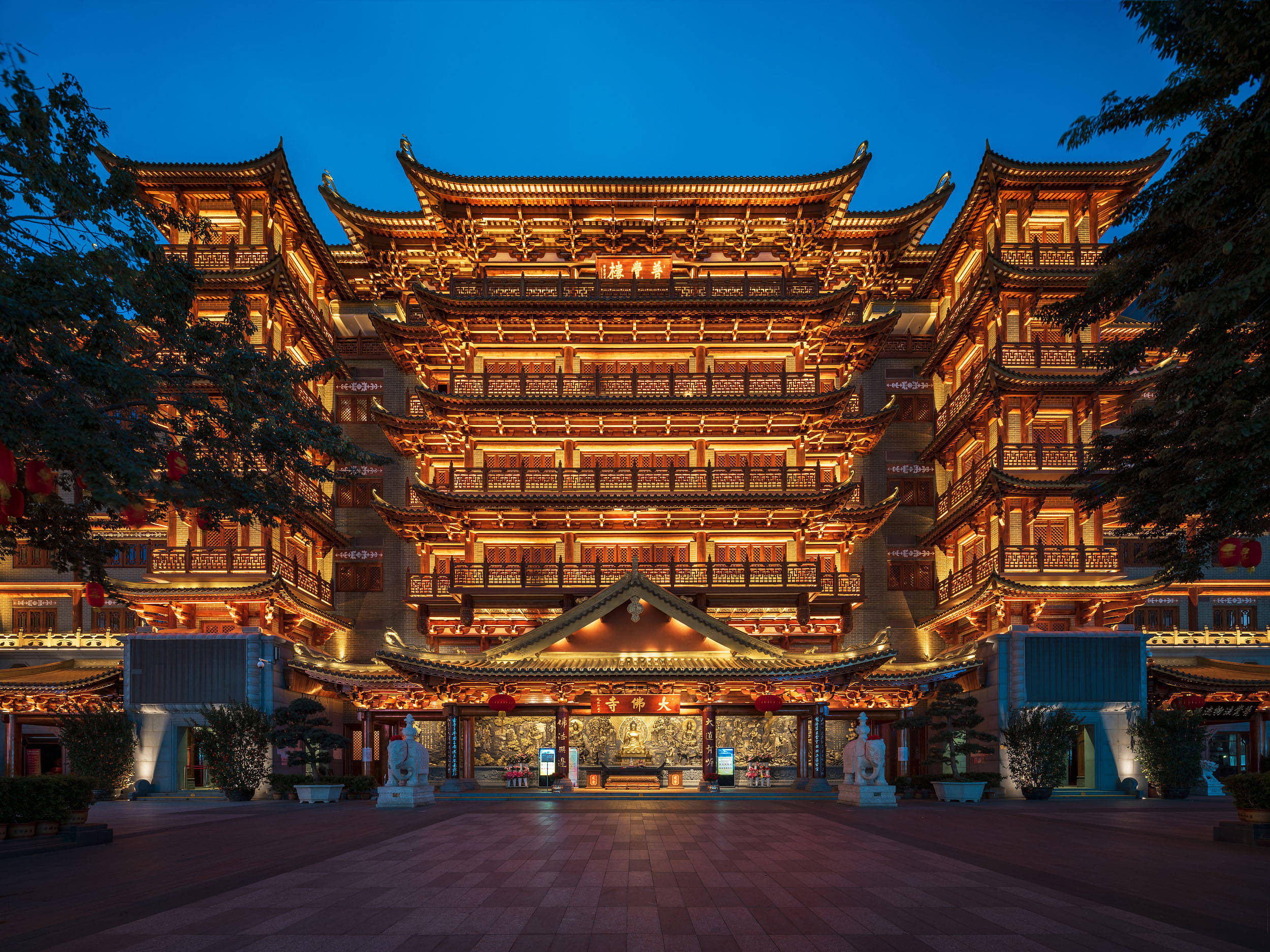 Guangzhou 桌布 壁紙 — 一個宏偉的傳統中國寺廟建築群，在黃昏時分以金色燈光映照在深藍色的天空下。