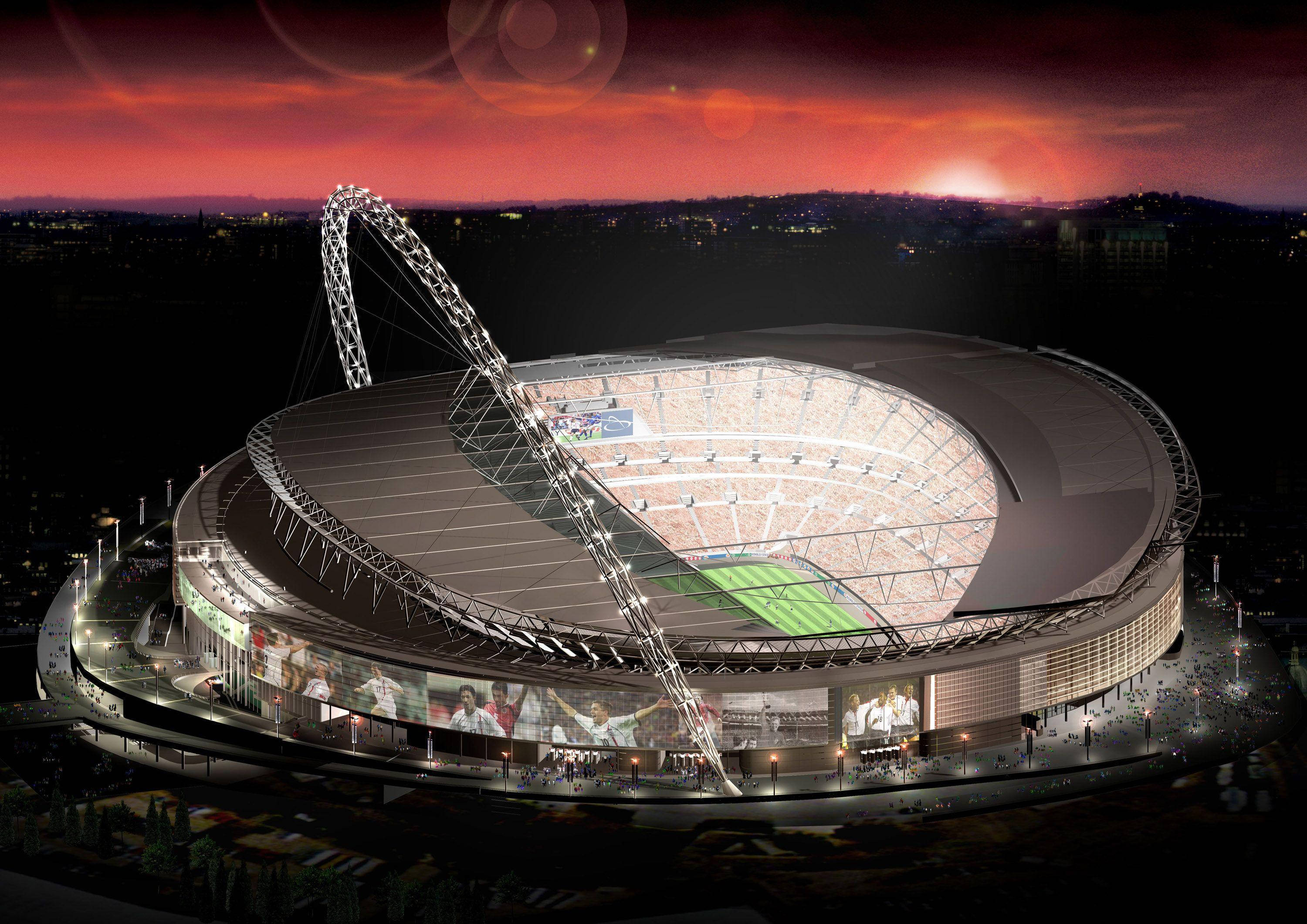 Stadium 桌布 壁紙 — 一個宏偉的照明體育場，擁有流線型屋頂和標誌性拱門，矗立在火紅的日落天空下。