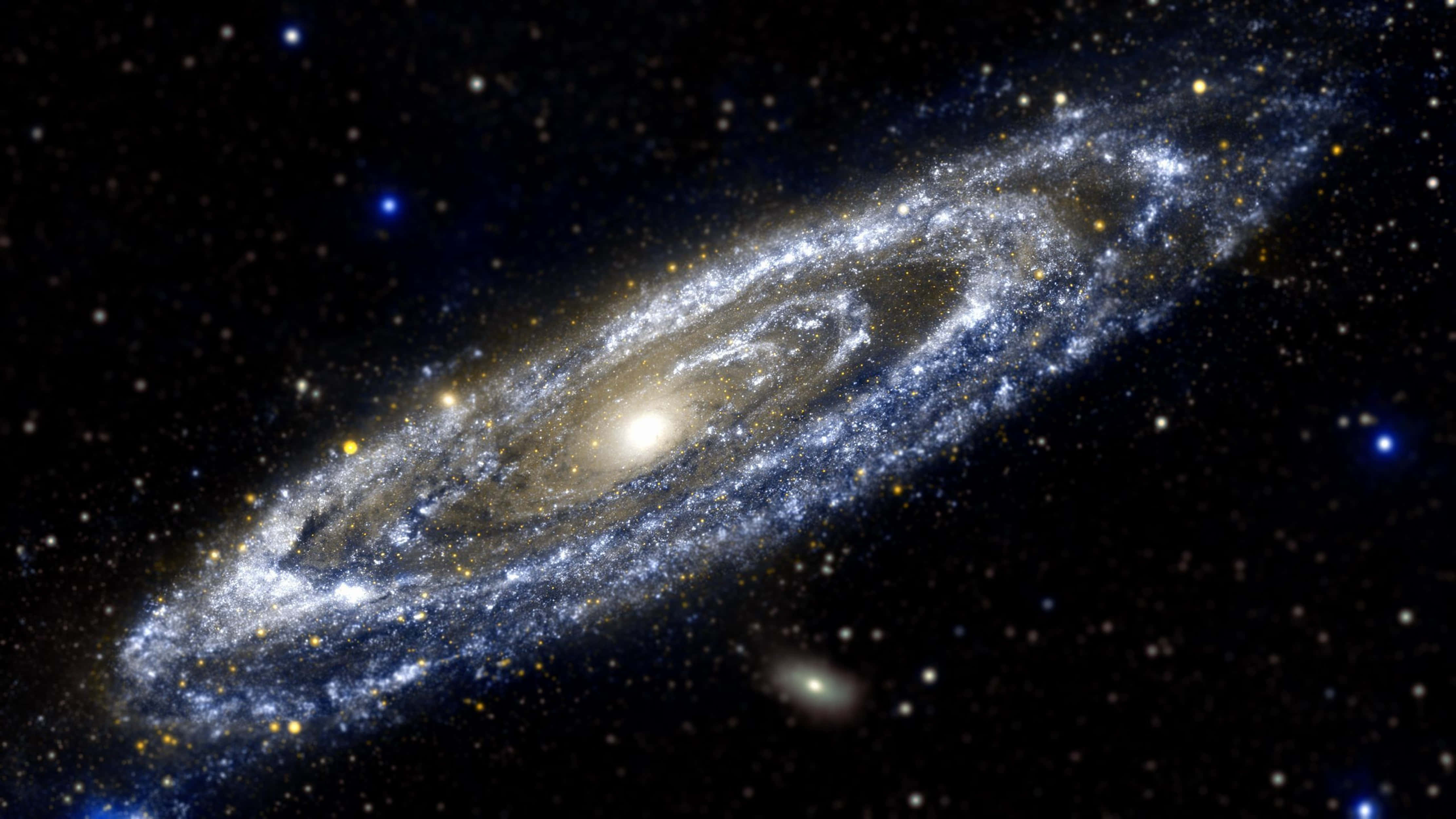 銀河 桌布 壁紙 — 一個宏偉的螺旋星系，其旋臂由恆星和宇宙塵埃組成，在星空背景下閃耀。